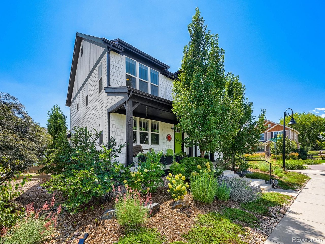 Come see why this beautifully maintained five-bedroom home in Indian Peaks South offers a refreshingly easy approach to Colorado living, pairing exceptional indoor and outdoor spaces with a neighborhood designed to be enjoyed.  Inside, an open, light-filled floor plan creates an effortless flow for both everyday living and entertaining. The beautifully appointed kitchen anchors the main level with crisp white cabinetry, quartz countertops, subway tile, gas cooktop, wall oven and microwave, and a generous center island with plenty of room to gather. A dedicated office with French doors provides a polished work-from-home space, while the adjoining living area and fireplace feel warm and inviting. Upstairs, four bedrooms are thoughtfully arranged with an upper-level laundry room and a spacious primary suite with private bath and walk in closet  The gorgeously finished lower level is well planned, offering a family room, flexible bonus space, 5th bedroom and stunning bathroom. Floor-to-ceiling tile, frameless glass and a steam shower with rain and dual shower heads give the space a decidedly elevated feel.  Outside, enjoy the best of both worlds. The private backyard is beautifully landscaped as an outdoor oasis for dining, entertaining or simply unwinding.  Just steps away, an expansive neighborhood park and community pool provide all the space you could want to play, swim and gather, while miles of nearby trails and open space invite you to get outside and explore.  Thoughtful energy-efficient features and a transferable leased solar system add to the home's value and ease of ownership, while an alley-accessed two-car garage keeps bikes and Colorado gear close at hand. Enjoy access to a pristine park, phenomenal pool and trails with open space just steps from your door - without the upkeep of a sprawling yard.  Downtown Louisville, the YMCA, restaurants and shops are minutes away, with Boulder and Denver within easy reach.