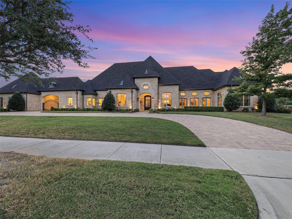 Located in the prestigious Estates of Craig Ranch—a gated enclave in southwest McKinney just minutes from the renowned TPC course where the Byron Nelson is held. This exceptional residence offers 4 bedrooms, 4 full baths, and 2 half baths, along with a 4-car garage and a dedicated golf cart bay. A circular drive provides a grand and welcoming entrance, leading into an open, light-filled interior adorned with hand-carved Italian marble columns and a magnificent Italian marble fireplace that serves as the home’s centerpiece. The gourmet kitchen is both functional and striking, featuring top-of-the-line appliances, a large central island, custom cabinetry, and a full scullery. The adjoining breakfast area overlooks the grounds and pool, creating a comfortable space for casual dining. Additional rooms include a formal dining room, piano room, media room, and tranquil garden room, designed to blend sophistication with everyday comfort. For those who work from home or desire a quiet retreat, a private office with exterior access provides both convenience and discretion, maintaining separate work home life. The primary suite is a serene retreat, with expansive windows offering beautiful views of the manicured grounds. The luxurious bath includes dual vanities, a soaking tub, and a spacious walk-in shower, designed with elegance and relaxation in mind. Expansive sliding doors open to the covered porch and full veranda, where an outdoor fireplace creates an inviting atmosphere for gatherings year-round. The backyard is a true retreat, featuring a large built-in grill and cook area, a recreational-style pool, a relaxing hot tub, and tranquil water features. Beyond the water feature, a custom firepit with surrounding seating provides the perfect place to unwind under the Texas stars. this McKinney estate defines casual elegance at its finest—a perfect harmony of beauty, comfort, and modern lifestyle in one of North Texas’s most desirable gated communities.