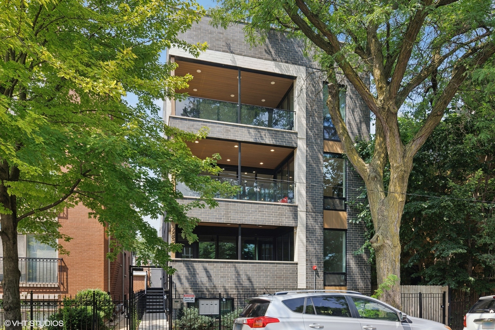 Welcome home to 2820 N Rockwell #2, where Logan Square meets Avondale. This extra-wide 3 bed, 2.5 bath simplex offers the best of elevated indoor-outdoor living-with a covered balcony featuring TimberTech composite decking (floor and ceiling), glass railing, and nearly 1,000 sq ft of fully upgraded private rooftop space complete with an outdoor kitchen, entertainment center, green space, and more.    Inside, the home is filled with natural light and thoughtful details: floor-to-ceiling windows, solid core doors, wide plank hardwood floors, and outfitted closets throughout. The chef's kitchen anchors the space with two-toned custom cabinetry, quartz countertops, a full-height backsplash, a generous island with waterfall edge, dedicated pantry, and an upgraded LG stainless appliance suite (including a WiFi-enabled range).    The oversized, spa-like primary bath includes heated floors, a deep soaking tub inside a porcelain-tiled shower room, and a double vanity. Additional features include a tankless water heater and EV-ready garage parking (one space included).    Tucked between Logan Square and Avondale, you're minutes from some of our favorite neighborhood spots-Maplewood and Ravinia Brewing, Four Letter Word Coffee, Ludlow Lounge, and more. Convenient to the North Branch trail, Target, HomeGoods, a movie theater, dog park, and local shops, with easy access to 90/94, the CTA Blue Line, and downtown.