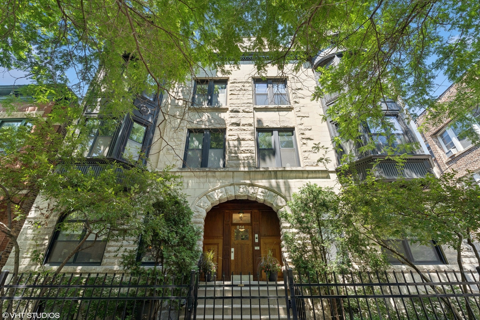 This pristine light filled 3bd/2ba penthouse is located on a beautiful treelined street in the heart of Lakeview! With soaring 12+ ft ceilings, hardwood floors, and crown molding throughout, this highly upgraded residence blends modern elegance with timeless character. The spacious, open-concept layout features a sun-drenched living and dining area with a south-facing bay window. The chef's kitchen boasts a large island with breakfast bar, granite countertops, stainless steel appliances, including a high-end stainless steel refrigerator, JennAir stove, and wine fridge, perfect for both cooking and entertaining. The expansive primary suite offers a walk-in custom closet and spa-like ensuite bath with a dual sink vanity, abundant storage, and a walk-in steam shower. Both the second and third bedrooms are generously sized and bright, complemented by a full guest bath. Enjoy the outdoor deck, accessible from both the back hallway and third bedroom, ideal for grilling, gardening, and outdoor dining. Additional features include in-unit washer/dryer and one included exterior parking space on-site. Located just steps from the Belmont El stop, lakefront, parks, grocery stores, and the endless dining, shopping, and nightlife along Broadway and Halsted, this home truly offers the best of East Lakeview living!