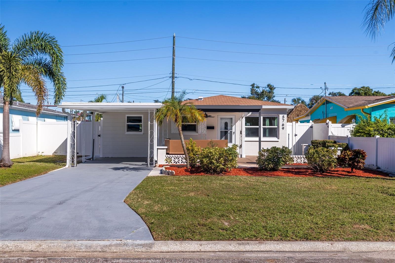 WELCOME HOME to this beautifully reimagined 3-bedroom, 2-bathroom residence in the heart of St. Petersburg! Nestled in an established neighborhood and situated in a desirable NON-FLOOD ZONE, this stunning, FULLY PERMITTED REMODEL combines modern elegance, everyday comfort, and the Florida lifestyle you've been dreaming of. From the moment you arrive, you'll be greeted by charming curb appeal, tropical landscaping, a spacious driveway, an oversized covered carport, and an inviting front patio. Step inside and immediately appreciate the bright, airy atmosphere, complemented by beautiful LUXURY VINYL PLANK FLOORING, fresh designer-inspired finishes, updated lighting, and abundant natural light. The thoughtfully designed TRUE SPLIT FLOOR PLAN offers the perfect balance of privacy and functionality, featuring three comfortable bedrooms and two beautifully remodeled bathrooms. At the heart of the home, the gorgeous kitchen showcases gleaming QUARTZ COUNTERTOPS, crisp white shaker-style cabinetry, stainless steel appliances, sleek hardware, and stylish contemporary fixtures. A dedicated dining area provides an inviting setting for everything from casual meals to memorable gatherings.Both bathrooms have been completely transformed with sophisticated finishes that elevate the home's overall design. Enjoy beautiful tilework, elegant vanities, stunning gold accents, and thoughtfully selected fixtures. One bathroom features a striking walk-in shower with designer tile and a rainfall showerhead, while the second offers a beautifully tiled bathtub and shower combination. Beyond the gorgeous cosmetic upgrades, this FULLY PERMITTED RENOVATION also features NEWER WINDOWS, AN UPDATED AC SYSTEM, AND A NEWER ELECTRICAL PANEL, offering added comfort and peace of mind. Step outside and discover your own private Florida retreat! The SPACIOUS, FULLY FENCED BACKYARD offers endless possibilities for outdoor enjoyment, while the expansive COVERED BACK PATIO creates an incredible setting for entertaining, outdoor dining, or simply unwinding after a long day. Surrounded by tropical landscaping, this generous outdoor space also includes a convenient storage shed and plenty of room to customize to your lifestyle. LOCATION IS EVERYTHING! Perfectly positioned just minutes from vibrant Downtown St. Petersburg, the charming Gulfport Arts District, and the Gulf Coast's beautiful beaches, this home places you within easy reach of exceptional dining, shopping, nightlife, entertainment, and waterfront attractions. Enjoy the convenience of being centrally located while still coming home to the peaceful atmosphere of an established residential neighborhood. Beautifully renovated, thoughtfully designed, and ideally located, this exceptional St. Petersburg home delivers the perfect combination of style, comfort, and convenience. Your Florida lifestyle awaits — schedule your private showing today!