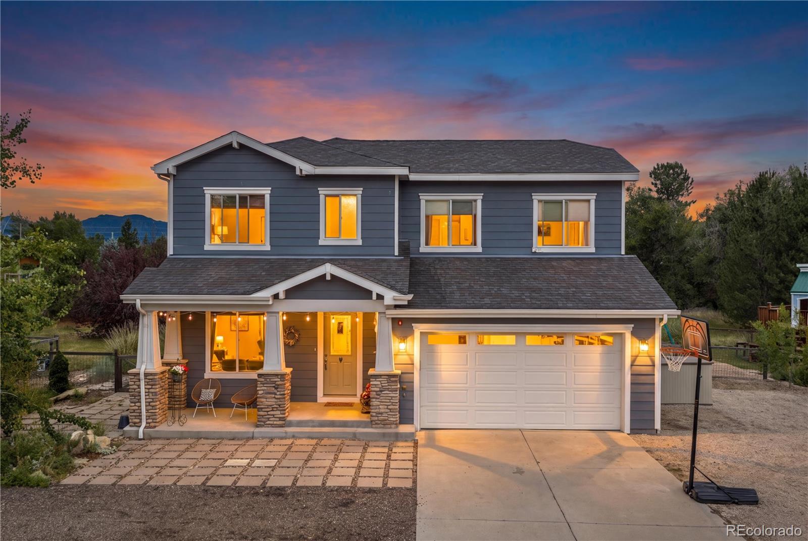 Welcome to this extraordinary luxury estate in Southeast Boulder, where a peaceful, rural-feeling sanctuary meets the convenience of the city. This remarkable property offers an expansive, private 1-acre lot zoned for an ADU, creating a rare canvas for your dream compound. Surrounded by mountain views, mature trees, and lush landscaping, the property features a secluded setting with limitless space to park your cars, trailers, boats, RVs, and campers, along with plenty of room for creative projects. A welcoming covered front porch guides you into the home, opening directly into an elegant front dining and family room that is bathed in abundant natural light. The floor plan then unfolds into a massive, open-concept main living space where the kitchen, central dining, and primary living room flow together seamlessly. Built for culinary excellence, the chef's kitchen features granite countertops and a huge central island equipped with a built-in range/oven and a breakfast bar. Tucked into the corner of the dining nook, a set of dual sliding glass doors frames the scenery, while the adjacent living room features even more sliding glass doors that open wide to erase the boundary between indoors and out. A full main-floor bathroom and direct access to the attached 2-car garage add effortless day-to-day utility, while a full-house water softener provides elevated comfort throughout. Upstairs, the primary bedroom suite serves as a peaceful retreat, boasting a massive walk-in closet and a full en-suite bathroom. A second large bedroom features direct access to this same primary bathroom via its own walk-in closet, offering a highly desirable option for dual primary suites. Two additional bright bedrooms, a second full bathroom, and a dedicated office nook complete the upper level. Outside, the grounds feature a gorgeous, sunny patio with a hot tub that leads out to gardens and a custom play structure. This foothills estate represents a truly unmatched lifestyle opportunity.