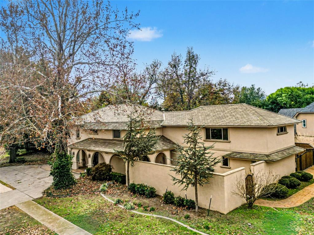LUXURY LIVING ON A PRIME .34 ACRE CORNER LOT IN THE HIGHLY DESIRABLE BROOKHAVEN ADDITION IN NORMAN, OK! From the moment you arrive, the striking stucco exterior, elegant wraparound covered porch, and private courtyard create a grand first impression that sets this home apart. Inside, a dramatic entry welcomes you with soaring ceilings, a statement staircase, and a stunning chandelier that highlights the home’s refined design. The main living area features a floor-to-ceiling stacked-stone fireplace, rich custom-built-ins, and a stylish wet bar with a beverage refrigerator—an impressive space designed for both entertaining and everyday luxury. The gourmet kitchen offers 4-inch granite countertops, bar seating, a commercial-grade refrigerator, a spacious breakfast area, and seamless flow into the formal dining room. A private guest bedroom with a full bath is located on the main floor, offering comfort and flexibility for visitors. Upstairs, the primary suite is a true retreat and one of the home's most impressive features, complete with its own sitting area or office. The spa-inspired bathroom includes heated floors, dual vanities, a jetted soaking tub, a separate walk-in shower, and a custom-designed closet with LED lighting, mirrors, and a private laundry area. A loft-style second living space overlooks the foyer, enhancing the open feel. Two additional bedrooms share a beautifully updated Jack-and-Jill bathroom featuring granite countertops, heated floors, LED mirrors, and designer tile. The backyard is a private resort-style oasis featuring a concrete pool, Jacuzzi, cedar pergola, and an 8-foot privacy fence. The swimming pool will be perfect for the upcoming warmer weather and will create an ideal setting for relaxing or entertaining. Additional upgrades include an impact-resistant roof and an electric gated entry. Located directly across from a park with walking trails, this home offers luxury, space, and an exceptional location. Buyer to verify schools.