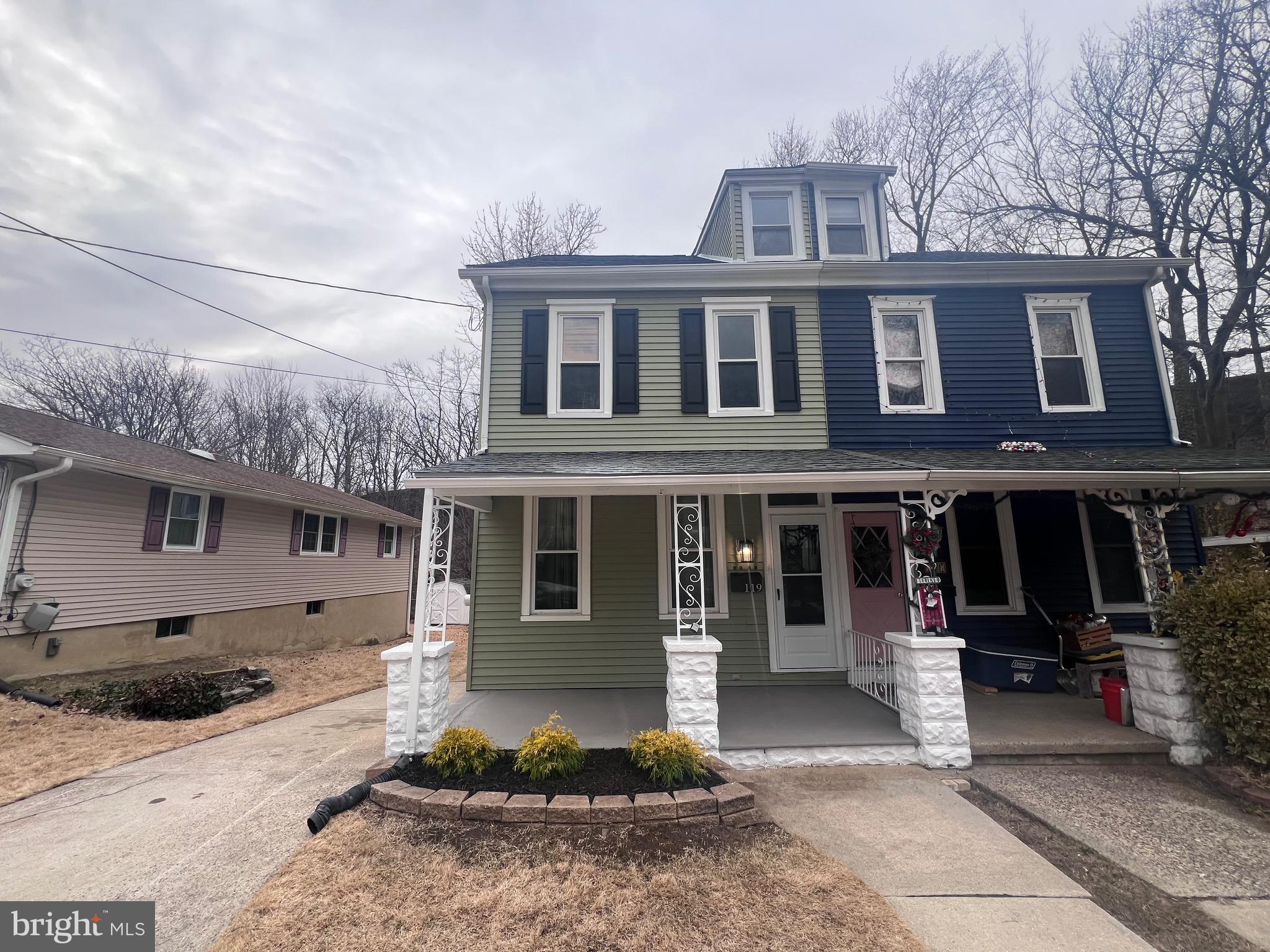 Welcome to 119 Albany Ave, a beautifully renovated home located on a quiet block in the charming township of Barrington, offering three spacious floors of thoughtfully designed living space with four bedrooms, 1.5 bathrooms, and a long list of stylish upgrades both inside and out. From the moment you arrive, the home’s curb appeal stands out with its freshly painted exterior, new roof, new black shutters, updated landscaping, and an inviting front porch complete with a new black mailbox, modern light fixture, and storm door—an ideal spot to relax with a morning cup of coffee. Inside, the home blends traditional character with modern finishes, featuring freshly painted Agreeable Gray walls, crisp white trim, new black interior doors, brushed nickel hardware, contemporary black lighting fixtures, and beautiful luxury vinyl plank flooring throughout. A welcoming foyer with high ceilings and new lighting leads to a spacious dining room highlighted by a striking black chandelier, while an elegant archway with classic woodwork opens into a generously sized living room with updated lighting. At the heart of the home is a bright chef’s kitchen showcasing two-tone cabinetry with naval blue lower cabinets and white uppers with crown molding, custom shelving, a pantry cabinet, granite and stained butcher block countertops, a chic backsplash, and high-end GE stainless steel appliances. The kitchen also features an island with new pendant lighting, brushed nickel and black fixtures, and recessed lighting, creating a perfect space for cooking and entertaining. Just beyond the kitchen is a custom-built laundry room with upgraded washer and dryer, a new white laundry cabinet and sink, crown-molded cabinetry, stylish backsplash, custom shelving, recessed lighting, and a mounted utility rack. This area also connects to a modern half bathroom featuring a new blue vanity, Delta faucet, black mirror and lighting, black hardware, and a towel rack above the white toilet, along with a convenient mudroom that leads to the fenced backyard. Upstairs, the staircase continues the home’s design theme with black treads, white risers, and new black railings with white spindles. The second floor includes three bedrooms and a beautifully updated hall bathroom with a new 42-inch blue vanity, black mirror and vanity light, Delta faucet, black hardware, and a tiled tub-shower combination. The spacious primary bedroom features two large closets and new modern lighting, while the additional bedrooms include closets, custom shelving, and new stylish fixtures. The third floor offers a large fourth bedroom with a bump-out, spacious closet, and additional under-eave storage. Outside, the property features a front, side, and fenced rear yard with a patio, two-car driveway, and updated exterior lighting, along with access to a freshly painted storage closet or workshop area complete with workbench, new lighting, and entry to a large clean lighted crawl space. The home also includes a full, clean basement equipped with an upgraded 150-amp electrical panel, a four-year-old HVAC system, a five-year-old water heater, sump pump, and fresh paint with white walls, slate gray floors, and black ceilings and beams. Conveniently located just steps from downtown Barrington, a short walk to Station Avenue in nearby Haddon Heights, and only minutes across the bridge from Philadelphia, this thoughtfully designed home offers modern comfort, character, and an unbeatable location within a welcoming community with strong local schools—making it a must-see property ready for its next owner.