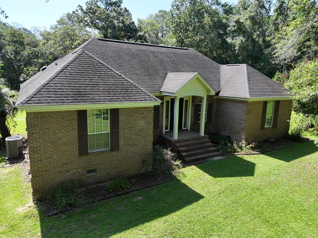 Peaceful country living on 5 acres. Welcome to 451 Beth Page Road, Thomasville, GA. This 3,069 square foot brick home sits just minutes from Leon County, Florida and Lake Iamonia in Southeastern Grady County. This 3-bedroom, 2-bath home features a foyer, vaulted living room with fireplace, formal dining room, and an eat-in kitchen with oak cabinets, center island, and double ovens. The master bedroom suite offers a large walk-in closet and updated bath with granite double vanities and a tile shower with waterfall head and wand. Enjoy the sunroom, covered back porch, spacious laundry room, and air-conditioned workshop with lean-to. The double carport with storage room adds to the amenities.  A winding driveway completes this private country setting, offering comfort and functionality in a beautiful South Georgia location. Click here for virtual tour: https://my.matterport.com/show/?m=8KFox4ms2kh&mls=1