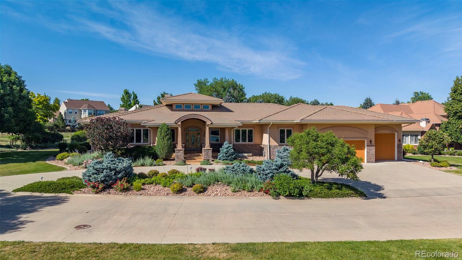 OPEN SAT 1-3 PM! Meticulously maintained by the original owners, this exceptional custom ranch-style home is perfectly situated on a premier .60 ACRE lot backing to walking trails & overlooking Eagle Trace Golf Course. Combining timeless design, quality craftsmanship, and spacious living, this remarkable home offers both luxury & comfort in one of Broomfield's most sought-after neighborhoods. A circular driveway & grand 2-story entry create a memorable first impression, showcasing custom woodwork & exceptional attention to detail thru-out. The expansive main level features 4,135 SQFT of living space with soaring ceilings & generously sized rooms designed for both everyday living & entertaining. The gourmet kitchen is equipped with high-end appliances, slab granite counters, large breakfast bar, walk-in pantry, and breakfast nook. It opens to the spacious living room, creating the ideal gathering space for family & guests. Step outside to the covered patio with outdoor kitchen & beautifully landscaped backyard. The luxurious primary suite serves as a private retreat, featuring a gas fireplace with custom stone surround, 5-piece bath & large walk-in closet w/ custom organization system. Two additional main-level bedrooms have their own ensuite baths providing privacy for family or guests. The finished lower level expands the living space with a large family room, wet bar, fireplace, exercise room & spacious guest suite w/ ensuite bath. An expansive unfinished area provides abundant storage or expansion opportunities. The oversized, climate-controlled 3-car garage is as immaculate as the home itself, featuring epoxy flooring, utility sink & direct access to a lower-level workshop space. An oversized garage door offers storage for your RV, Boat, Sprinter or Airstream. Located in the highly desirable Broomfield Country Club community, residents enjoy convenient access to golf, parks, trails, top-rated schools, shopping, dining & easy access to Denver/Boulder.