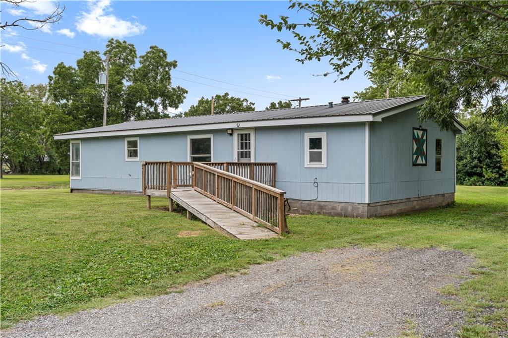 Welcome to this 4-bedroom, 2-bathroom home in Rich Hill, Missouri! Built in 1997 and sitting on a corner lot, this property has been thoughtfully updated to bring a modern look and easy-living feel. Step inside to find an open floor plan with durable LVP flooring throughout and a crisp white-and-grey color scheme that’s as stylish as it is practical.

The kitchen is ready to go with a full appliance package included, making move-in day a breeze. The primary suite gives you a comfortable retreat, while three additional bedrooms and a second full bath offer plenty of space for everyone. Central heat and air keep the home comfortable year-round.

Outside, enjoy morning coffee or evening sunsets from the front deck, make use of the small detached storage shed, and know you’re covered with a low-maintenance metal roof. The corner lot adds convenience and curb appeal to round it all out.

This updated home blends modern finishes with everyday function—room for everyone, space for everything, and comfort built right in. Call the listing agent today to schedule your tour of the property!