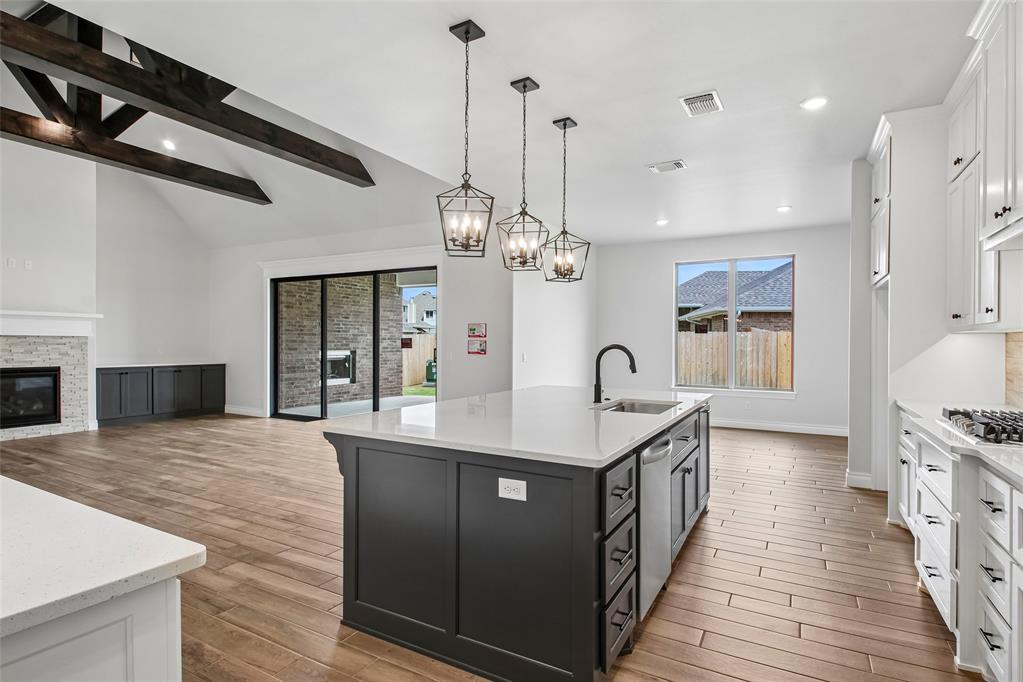 This Wesley Bonus Room floor plan includes 3,630 Sqft of total living space, which features 3,285 Sqft of indoor living space and 345 Sqft of outdoor living space. There is also a 590 Sqft, three-car garage with an in-ground storm shelter installed! This desirable home offers 5 bedrooms, 3 full bathrooms, covered patios, a large bonus room, a powder room, and a utility room featuring a utility sink. The great room supports an immaculate cathedral ceiling with a crows feet detail and a ceiling fan, a luxurious 3-panel sliding door with a 4’ back patio extension, wood-look tile, rocker switches throughout, Cat6 wiring, eggshell paint, and a gas fireplace featuring a stacked stone detail and built-in lower cabinets on both sides. The upscale kitchen boasts stunning pendant lighting, stainless steel appliances including double ovens and a 5-burner cooktop, 3 CM countertops, vogue tile backsplash, well-crafted cabinets to the ceiling with cabinet hardware throughout and under cabinet lighting, decorative end panels, a separate walk-in pantry, and a large center island that holds a roomy sink, a dishwasher, and a trash can pullout. The primary suite provides a sloped ceiling detail, a ceiling fan, a plush carpet finish, and windows. Attached is the main bath, which has a bat-winged vanity with framed mirrors, 3 CM countertops, a large European walk-in shower, a private water closet with an elongated toilet, a free-standing tub, and a HUGE walk-in closet! The covered outdoor living area welcomes a wood-burning fireplace, a gas line for your grill, and a handy TV hookup. Other included features for this elegant home include our healthy home technology, an air filtration system, a tankless water heater, double glazed vinyl low E windows with argon, R-44 and R-15 insulation, a fresh air ventilation system, and so much more!