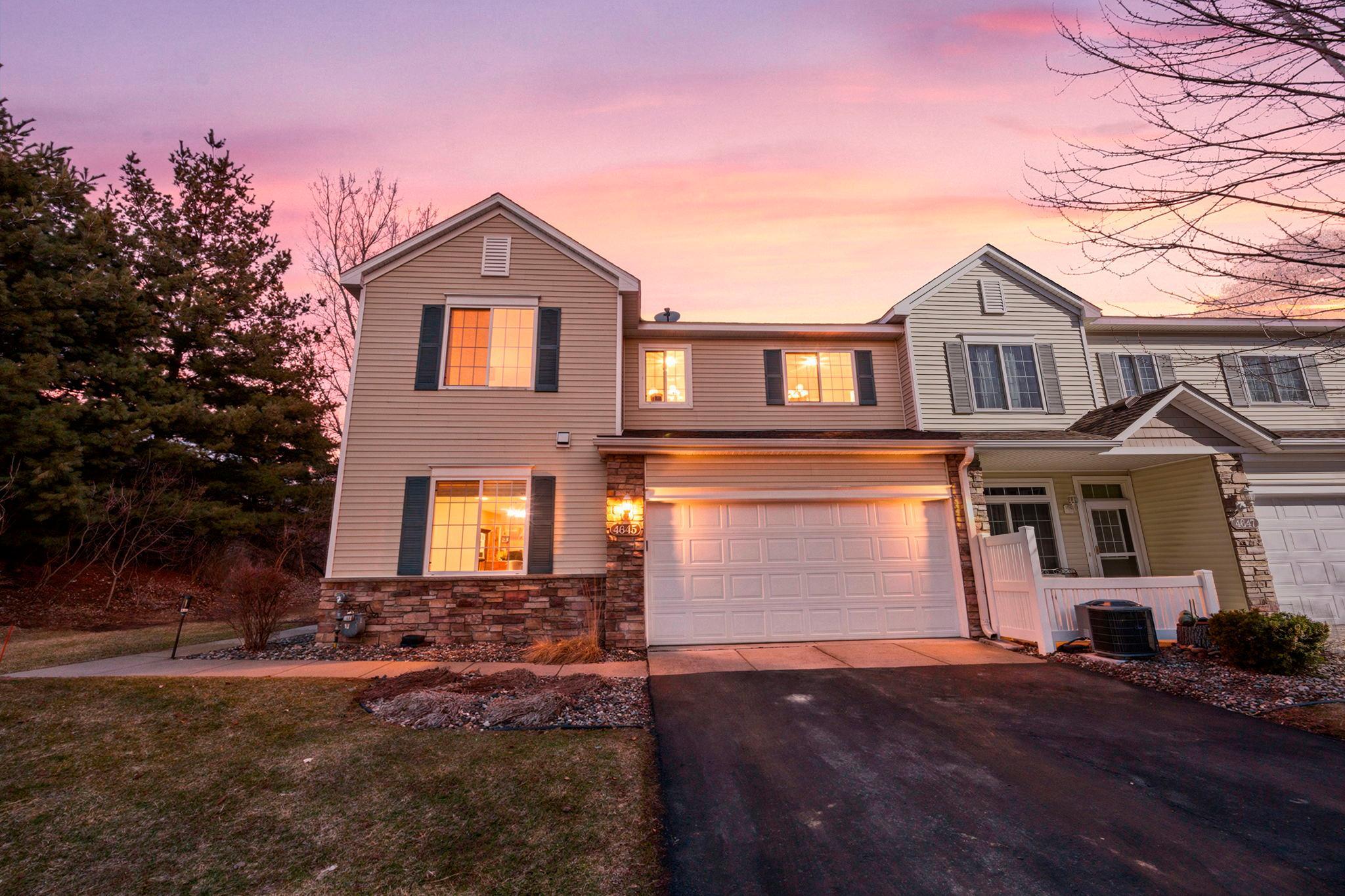 Beautifully maintained 2-bedroom, 2-bathroom end-unit townhome in a peaceful Inver Grove Heights neighborhood, just steps from scenic ponds, parks, and Southview Country Club, with easy access to major roadways for a seamless commute.The inviting main level features 9-foot ceilings and abundant natural light, creating a bright, welcoming atmosphere. The cozy living room offers plush carpeting and a Heat-N-Glo fireplace, perfect for relaxing or entertaining. The open-concept layout flows into the dining area with statement lighting and a stylish kitchen complete with stainless steel appliances, under-cabinet lighting, a two-tier peninsula with breakfast bar seating, and a walk-in pantry. A powder room, spacious closet, and attached 2-car garage add everyday convenience.Upstairs, a versatile loft provides ideal space for a home office, media room, or additional living area. Two generously sized bedrooms include ceiling fans, with the primary offering a large walk-in closet. The oversized full bath features both a walk-in shower and tub/shower combination. Upper-level laundry adds ease to everyday routines. Enjoy a private front patio and serene surroundings!
