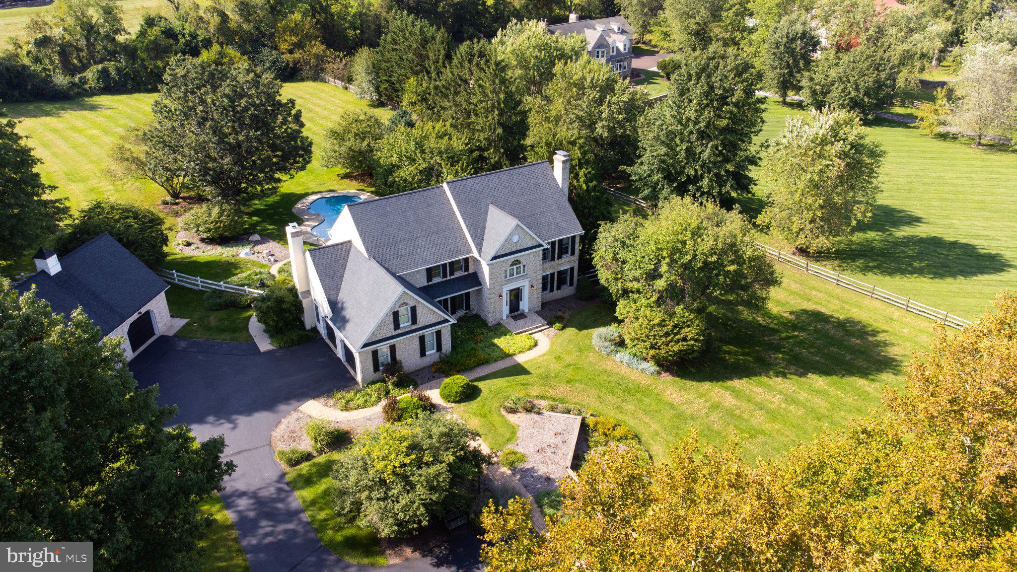 Discover an exquisite blend of luxury and comfort in this stunning residence, nestled on a sprawling 2.5-acre estate. This meticulously crafted home offers just under 4,000 square feet of elegant living space, featuring four spacious bedrooms and three and a half bathrooms. The heart of the home is the grand living area, highlighted by a wood-burning fireplace, creating the perfect setting for cozy evenings. A second wood-burning fireplace in the dining room adds even more warmth and character to the home.The spacious primary suite offers a luxurious retreat, complete with a zero-entry shower for both style and convenience. Step outside to your private oasis, where a saltwater in-ground pool invites relaxation and entertaining amid beautifully landscaped grounds. The fully finished basement, complete with an outside entrance, provides endless possibilities for recreation, entertaining, or additional living space.An oversized attached garage and detached garage offer abundant storage and parking, while additional side parking in the front provides even more convenience for guests and everyday living. Enjoy the privacy and tranquility of your expansive surroundings while remaining just moments from upscale amenities. This exceptional property offers the perfect combination of luxury, comfort, space, and privacy—a true lifestyle opportunity waiting to be embraced.