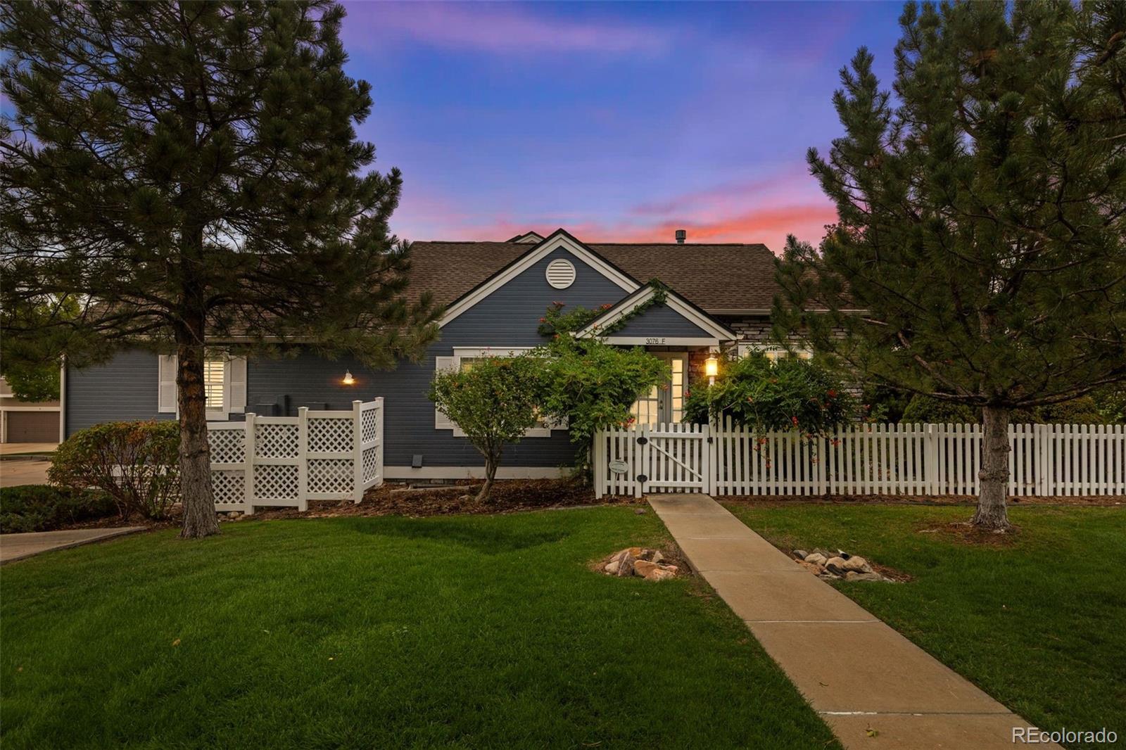 Welcome to 3076 W 112th Court, where soaring ceilings, beautiful natural light, and thoughtful updates come together in one inviting Westminster home. From the moment you step inside, warm hardwood floors and an open layout create a bright, comfortable feel. The spacious living room features a vaulted ceiling, a large statement window, built in shelving, and a fireplace that gives the room a welcoming focal point. Plantation shutters throughout the main living spaces add a polished finishing touch. Just beyond, the dining area flows easily into the kitchen, creating a connected space that works well for everyday living and entertaining. The kitchen features white cabinetry, granite countertops, stainless steel appliances, a tile backsplash, generous workspace, and a center island for additional prep space. The main level includes a spacious primary bedroom with vaulted ceilings and direct access to a private five piece bathroom featuring a long granite vanity, soaking tub, separate shower, and walk in closet. A second bedroom, full bathroom, and conveniently located laundry area complete the main floor. Downstairs, a finished bedroom adds flexibility for guests, home office, or additional living space. Beyond the finished bedroom, the basement offers a large unfinished area with plenty of potential to make it your own, whether you envision a recreation room, workout space, or additional storage. Outside, mature landscaping surrounds a private patio and stone pathway, creating a peaceful outdoor setting with room to sit, dine, or enjoy the Colorado seasons. The location puts you close to Cotton Creek Park and Westfield Village Park, with Westminster City Park just a short drive away. Shopping, dining, and entertainment are also nearby at Westminster Promenade and The Orchard Town Center, giving you plenty of options for recreation and everyday convenience. Come check it out today!