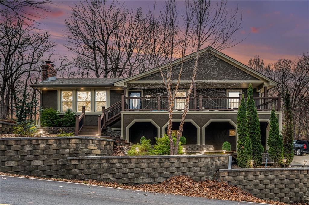 Charming lake home situated on three spacious second-tier lots, offering both privacy and easy access to a covered boat dock. The interior has been freshly painted, complemented by new flooring, creating a bright and inviting atmosphere. Large windows flood the home with natural light while providing stunning views. Step outside to an expansive back deck and a generous side patio—perfect for entertaining or simply enjoying the serene, park-like backyard that backs up to lush green space. With ample parking, there's plenty of room for guests to visit and enjoy this beautiful retreat.