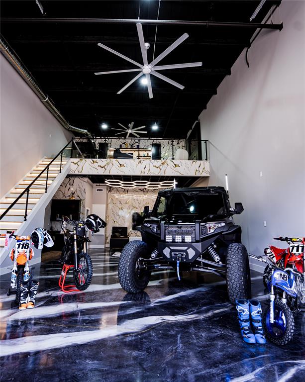 Experience the ultimate blend of luxury, functionality, and automotive lifestyle in this fully customized 1,602-square-foot loft-style garage. Located within an exclusive gated 3.5-acre development featuring just 63 privately owned suites, this exceptional unit has been thoughtfully upgraded to create a sophisticated retreat for collectors, entrepreneurs, and enthusiasts alike.The expansive 25' x 50' floorplan showcases soaring ceilings, sleek epoxy flooring, and contemporary industrial architecture, while a custom-built mezzanine maximizes usable space and enhances the loft-inspired design. Premium finishes throughout include a private lounge with fireplace ideal for entertaining, a beautifully appointed custom bathroom, and a climate-controlled custom wine cellar that adds a refined touch rarely found in this unique asset class.Designed to accommodate luxury vehicles, exotic car collections, recreational equipment, or a personalized showroom environment, the flexible open-concept layout easily adapts to a variety of uses. Whether serving as a private automotive gallery, executive office, showroom, or creative studio, the possibilities are virtually limitless.Owners enjoy the security and convenience of gated access, along with the camaraderie of a vibrant community of like-minded collectors and professionals. Combining secure storage, luxury amenities, and exceptional versatility, this one-of-a-kind property offers a rare opportunity to own a truly distinctive lifestyle investment.