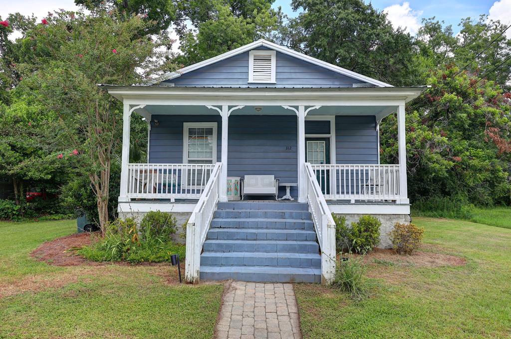 Step into the timeless charm of this beautifully maintained 1925 cottage, ideally located just two blocks from Historic Downtown Thomasville. Enjoy an easy stroll along the original brick streets to charming boutiques, locally owned shops, and regionally acclaimed restaurants. Paradise Park and the Thomas County Public Library are also within walking distance, making this location one of Thomasville's most desirable.  Inside, this bright and airy 3-bedroom, 2-bath home blends classic character with thoughtful modern updates. High ceilings and abundant natural light create an inviting atmosphere throughout. The spacious kitchen is designed for gathering, featuring a large island with seating for five, warm butcher block countertops, and a gas range that's perfect for preparing everything from weeknight dinners to holiday feasts.  The newly remodeled guest bathroom showcases a beautiful tiled walk-in shower, while the primary bath retains its vintage charm with an elegant antique claw-foot soaking tub. Relax on the expansive front porch, or unwind on the large rear deck overlooking a peaceful, wooded backyard that offers both privacy and tranquility.  The surrounding neighborhood is experiencing exciting reinvestment, with attractive new construction planned directly across the street and the restoration of a neighboring historic home already underway. The home also enjoys a prime location directly across the corner from the popular Biscuit Company Event Center, adding to the area's growing appeal and vibrant atmosphere.  Currently operating as a highly successful short-term rental with a consistent history of occupancy since 2022, this property is being offered fully furnished and completely equipped, providing a true turnkey investment opportunity. Whether you're looking to continue its proven success as a vacation rental, purchase a weekend getaway, or settle into a move-in-ready home in one of South Georgia's most beloved historic communities, this exceptional cottage is ready to welcome you home. Financial records and occupancy history available upon request with qualified offer.