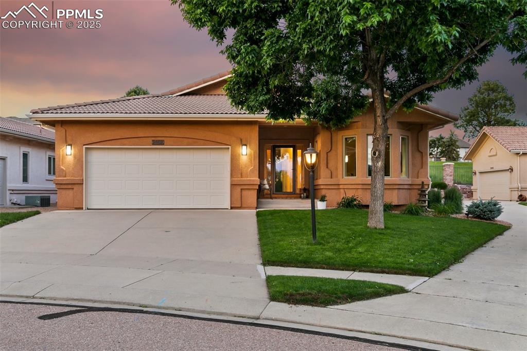 Designer updates and elegant finishes shine in this move-in ready stucco patio home, ideally located at the end of a quiet cul-de-sac on Pine Creek Golf Course. With a tile roof and HOA-covered lawn care, irrigation, and snow removal, this 4-bedroom, 4-bathroom home with a dedicated office offers near maintenance-free living. Enjoy stunning views of Pikes Peak from the front of the home and through the bay windows in the office. The thoughtfully designed, modern open floor plan is perfect for entertaining, featuring a separate dining area and an expansive outdoor patio that runs the full length of the home. The gourmet kitchen includes granite countertops, a gas cooktop, and newer stainless-steel appliances including double convection ovens. The light-filled, fully finished basement offers a wet bar, fireplace, three bedrooms, and two baths—ideal for hosting family and guests. Tasteful upgrades throughout include a dramatic two-story stone fireplace, Pella windows upstairs, tankless water heater, newer furnace and A/C, custom office feature wall, reinforced clear window well covers for added light and insulation, and fresh interior paint. Additional highlights include new carpeting, updated lighting, faucets, fans, granite counters in the wet bar and half baths, a new gas fireplace with tile surround in the family room, vinyl mat garage floor, and extensive landscaping improvements. This truly turnkey home is located in the highly sought-after Pine Creek community—don’t miss your chance to make it yours!
