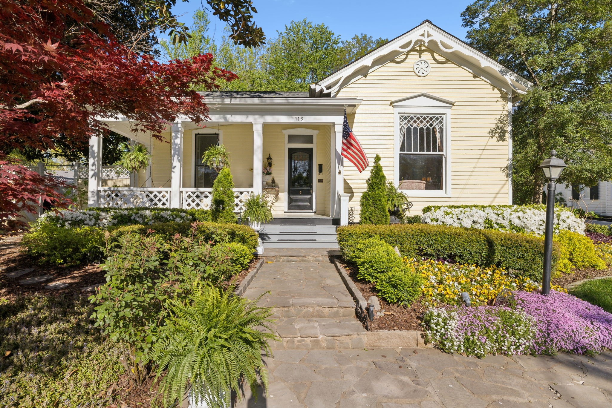 Nestled gracefully within Franklin’s treasured historic district, this circa-1870 Victorian residence is a masterclass in enduring Southern elegance. Just two and a half blocks from Main Street’s boutiques, galleries, and the beloved Franklin Theatre, the home seamlessly blends the romance of a bygone era with the comforts of refined, contemporary living.  From the moment you step onto the gracious front porch, the charm is palpable. Inside, soaring ceilings and original hardwood floors set the tone for a series of light-filled spaces, artfully connected by a thoughtfully unique floor plan. Architectural details abound—from ornate transoms and intricate latticework to the distinguished symmetry of the formal hallway.  At the heart of the home, three sets of French doors open wide to reveal a secret garden: a tranquil brick and flagstone courtyard centered around a tiered fountain, blooming with seasonal color and framed by manicured boxwoods. The park-like backyard, dotted with mature trees, invites quiet moments of reflection or effortless entertaining beneath the open sky.  Additional highlights include an enclosed herb garden, a breezeway-connected two-car garage, and modern conveniences like full irrigation and professional outdoor lighting—each element curated with exquisite care. Listed on the National Register of Historic Places, this meticulously maintained property is not just a home—it is a legacy of style and story in one of Tennessee’s most coveted locations.