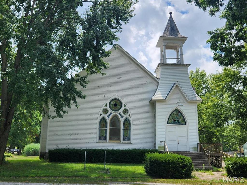 Historical church with approximately 3,100 sf built in 1859 features all original stained glass, woodwork, pocket doors, etc.  There is a 1/2 bath located off the fellowship hall.  Sale includes all furnishings including curved pews, altar, organ, tables & chairs, seasonal decorations, etc.  Public park is located across the street.  Lots of possibilities for this property!