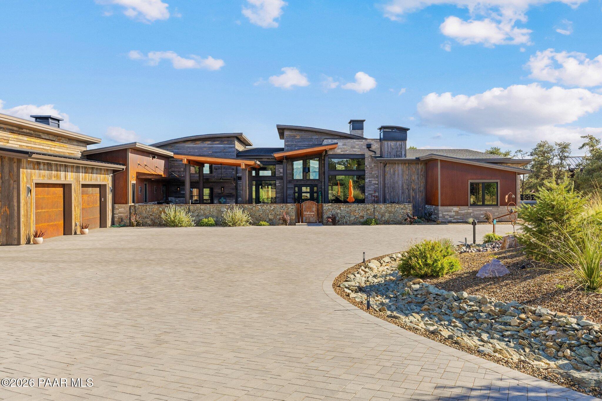 Architectural Masterpiece  6,287 sq. ft.  under roof set upon approximately 2 acres within Talking Rock Golf Community, this estate completed in 2024 redefines luxury living in Northern Arizona. From the moment you step into the private entry courtyard, complete with a full outdoor kitchen, you'll sense this home was designed to make a lasting impression.  The 3,368 sq. ft., 3 bedrooms , 2.5 bathrooms main residence delivers a striking architectural statement with an open floor plan, floor-to-ceiling windows flooding the interior with natural light, and sightlines that open seamlessly to an expansive Trex deck built for entertaining or simply soaking in the private views. Inside, barrel-vaulted ceilings finished with Wyoming snow paneling and stone fireplaces set a dramatic tone, while tile flooring runs throughout for a clean, elevated feel.  The chef's kitchen, outfitted with premium Wolf and Sub-Zero appliances plus a full butler's kitchen, makes hosting effortless.A detached 729 sq. ft. casita offers flexible living space w/ full kitchen , ideal for guests, extended family, or a private retreat. The property also features an attached 3 car garage and an oversized RV garage, currently home to a golf simulator and basketball court and a golf cart that convey with property.  Thoughtfully engineered for comfort and efficiency, this estate includes radiant heat flooring, owned solar panels, and a tankless water heater.  This is a rare opportunity to own new construction in one of the region's premier golf communities architectural excellence paired Legacy Builder and resort caliber amenities on acreage.