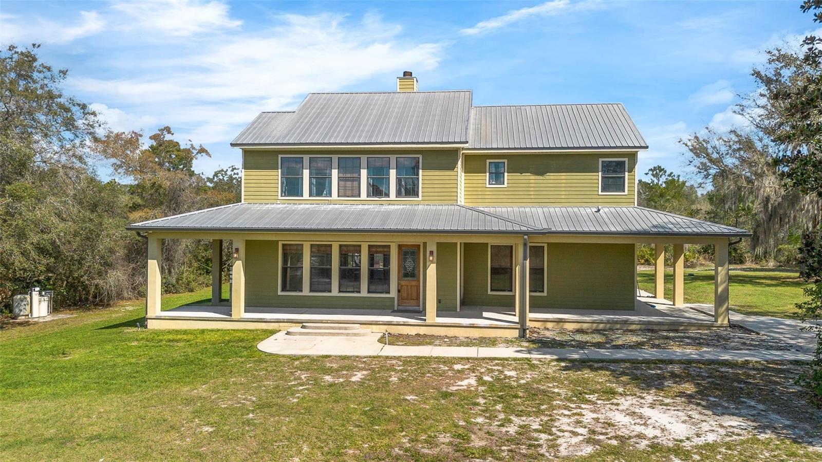Set on over 4 fully usable acres in Osteen, this custom-built estate offers a rare combination of privacy, space, and long-term potential that’s nearly impossible to replicate today. This 4-bedroom, 3-bathroom home spans over 3,100 square feet of living space, designed with functionality and scale in mind. From the moment you pull in, you feel the separation—no tight subdivisions, no HOA, just open land and the ability to live the way you want.Inside, the layout delivers both comfort and practicality. A spacious kitchen with solid wood cabinetry and an island opens into the main living areas, creating a natural flow for everyday living and entertaining. The primary suite is positioned upstairs with generous proportions, dual sinks, and separation from guest bedrooms—ideal for families or multi-generational living.Step outside and this is where the property really takes over.A true resort-style pool With Waterfalls anchors the backyard, complete with a jacuzzi—built for year-round use whether you’re hosting, unwinding after a long day, or spending weekends at home. This setup feels intentional and designed for the lifestyle, not added as an afterthought.Surrounding the home is over 4 acres of private, buildable land—giving you the flexibility most buyers are searching for right now. Add a guest house, detached garage, barn, or workshop. Create a full family compound. Bring animals. Park your equipment. Or keep it simple and enjoy the space, the quiet, and the freedom.There’s already a private trail running through the property—perfect for riding, walking, or letting the dogs run without ever worrying about traffic or neighbors. This is the kind of land where you can actually use every inch.The wrap-around porch ties it all together, giving you a place to slow down and take in what you own—something that’s becoming harder to find in Central Florida.From a structural standpoint, the home is built to last with block construction, a durable metal roof, well and septic, and no HOA restrictions—giving you full control over how the property evolves over time.Location-wise, you’re positioned for both privacy and accessibility—just a short drive to shopping, dining, and major roadways, while still feeling completely removed from the noise. Nearby natural areas and trails only add to the lifestyle this property offers.Properties like this aren’t just homes—they’re long-term holds. With limited inventory offering acreage, a pool, jacuzzi, and buildable land together, opportunities like this don’t come around often.If you’re looking for space, privacy, and the ability to create something beyond a standard home—this is where it starts.