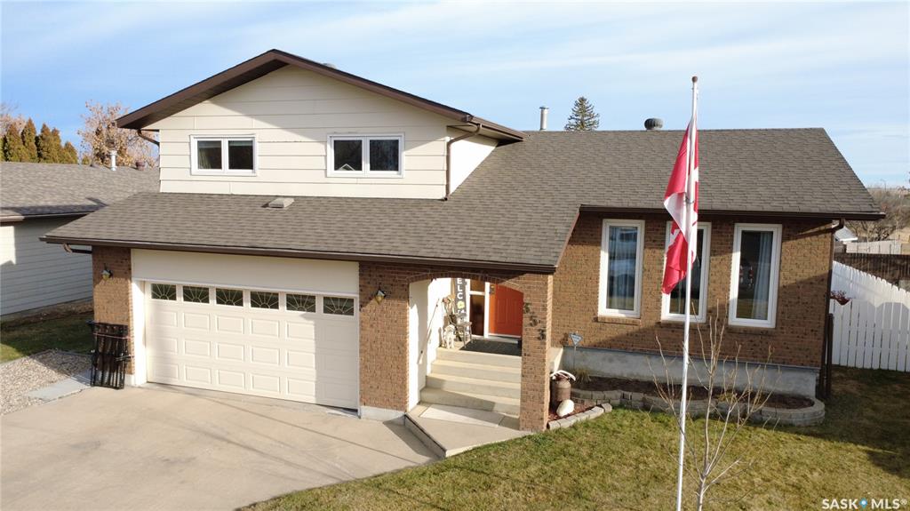 This 1,738 sq. ft. four-level split at 353 Walsh Trail, Swift Current, is built for real family life, offering plenty of space to grow while still feeling warm and welcoming. The main level brings everyone together with trusted oak kitchen cabinetry that has stood the test of time, a large sit-at island with seating for four that easily becomes the centre of breakfasts, homework, and late-night chats, and a built-in China cabinet that adds both charm and storage. The bright dining area sits right off the kitchen, while the living room is grounded by hardwood floors and a built-in entertainment centre that creates a cozy yet functional gathering space. Just a few steps down, the family room is where movie nights and playtime naturally land, with patio doors leading out to the back deck and a fully fenced yard that feels safe and private for kids and pets. Upstairs, you will find 3 well-sized bedrooms, a 4-piece bathroom, and a primary bedroom complete with its own 3-piece ensuite, giving parents the opportunity to get ready at the same time as the kids. The fourth level offers even more flexibility with a rec room that works equally well as a teen hangout, home gym, or games area, plus a 3-piece bathroom and a spacious laundry/storage room that keeps life organized. Outside, the backyard includes a garden area for growing your own vegetables, a storage shed, and vinyl fencing, and opens to a lovely green space. The front gravel parking pad is ideal for an RV or extra vehicles. An attached 22 x 21 double garage walks directly into the home, making busy mornings, grocery runs, and winter weather far easier to manage. With updates including triple-pane PVC windows, newer kitchen appliances, updated light fixtures, select flooring, and the advantage of quick possession, this is a home where routines run smoothly, milestones are celebrated, and family memories naturally take shape.