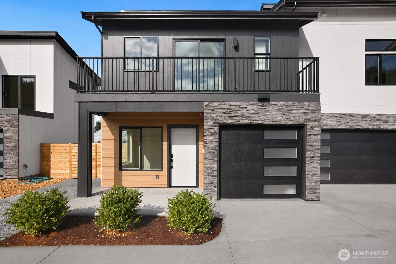 Last unit available in this development! Exquisite craftsmanship and elevated finishes define this stunning, modern new-construction home, ideally situated on a quiet street just minutes from Downtown Burien’s dining, shopping, and popular weekly Farmers Market. This is a rare opportunity to own brand-new construction with exceptional style and value. Step inside to discover a bright living area and dining area designed for modern living. The U-shaped kitchen is a chef’s delight, featuring quartz countertops, a full-height backsplash, soft-close cabinetry, under-cabinet lighting, and sleek contemporary finishes throughout. Upstairs, you’ll find two light-filled bedrooms both with spacious full bathrooms, a balcony off the front bedroom, and a dedicated laundry room for added convenience. Enjoy year-round comfort with an energy-efficient mini-split heating and cooling system. Thoughtful details abound, from the keyless-entry front door and Google Nest doorbell to the dedicated EV-ready garage designed for today’s lifestyle. Seller is offering a $5,000 credit toward the buyer’s choice of refrigerator, washer and dryer, providing the flexibility to personalize your new home from day one.