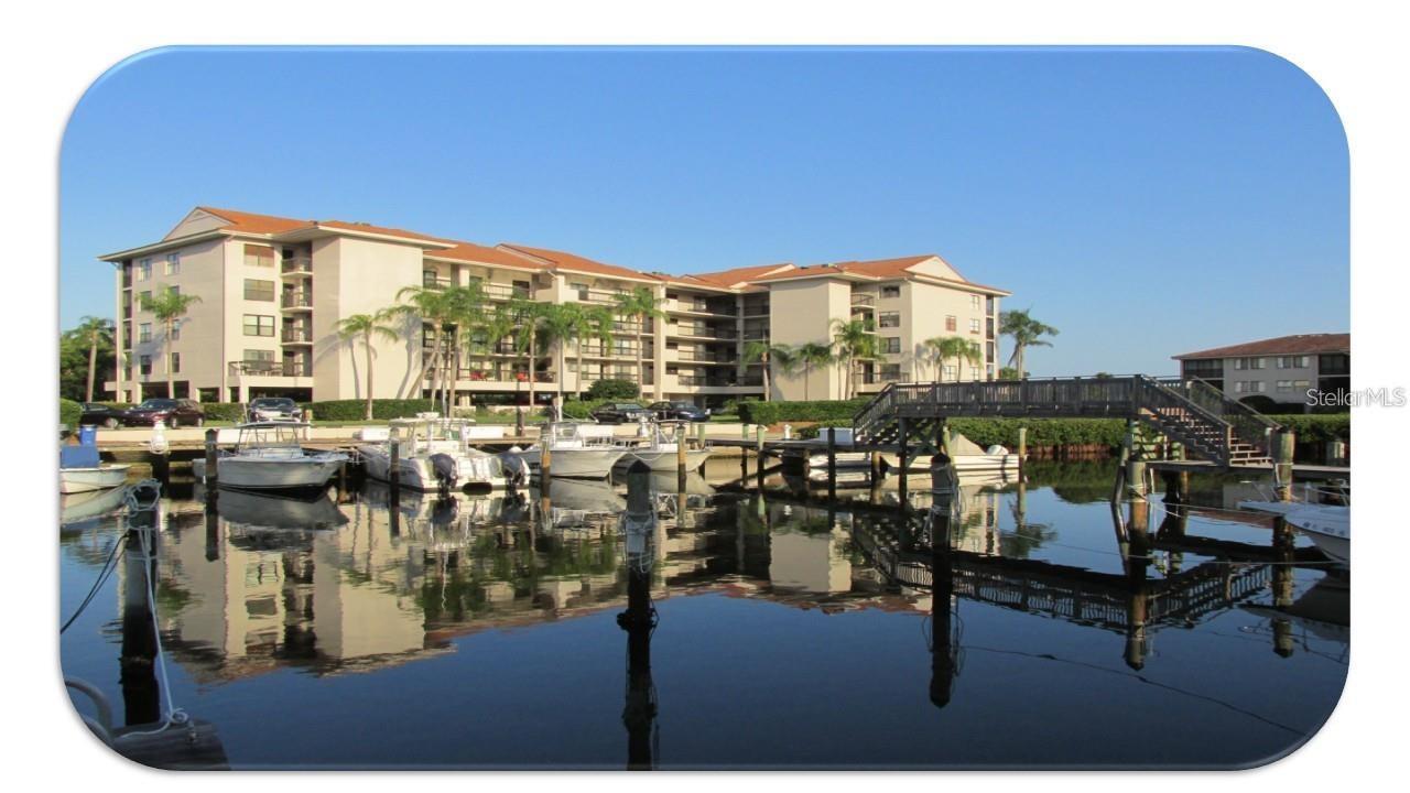 Experience the tranquility of this 24/7 gated Gulf waterfront community and resort-style living at its finest with it's pools, spa, tennis courts, fitness center, putting green, bocce court, fishing pier, walking trail, and art studio in this highly sought-after, upper-floor (with elevator), end unit offering panoramic wrap-around views of the Gulf, Nature Preserve and Marina. This fully furnished unit is perfect for anytime getaways, a lucrative rental investment, or your permanent private paradise.  This unit offers (2) bedroom/bath suites, but easily sleeps six thanks to a cleverly integrated Murphy bed. One of only two buildings in the entire complex that offers garage under-the-building assigned parking.  Boaters will love being just steps from the private marina, offering Gulf access within minutes—not hours—for all kinds of boats from kayaks to 40-foot vessels to sailboats!