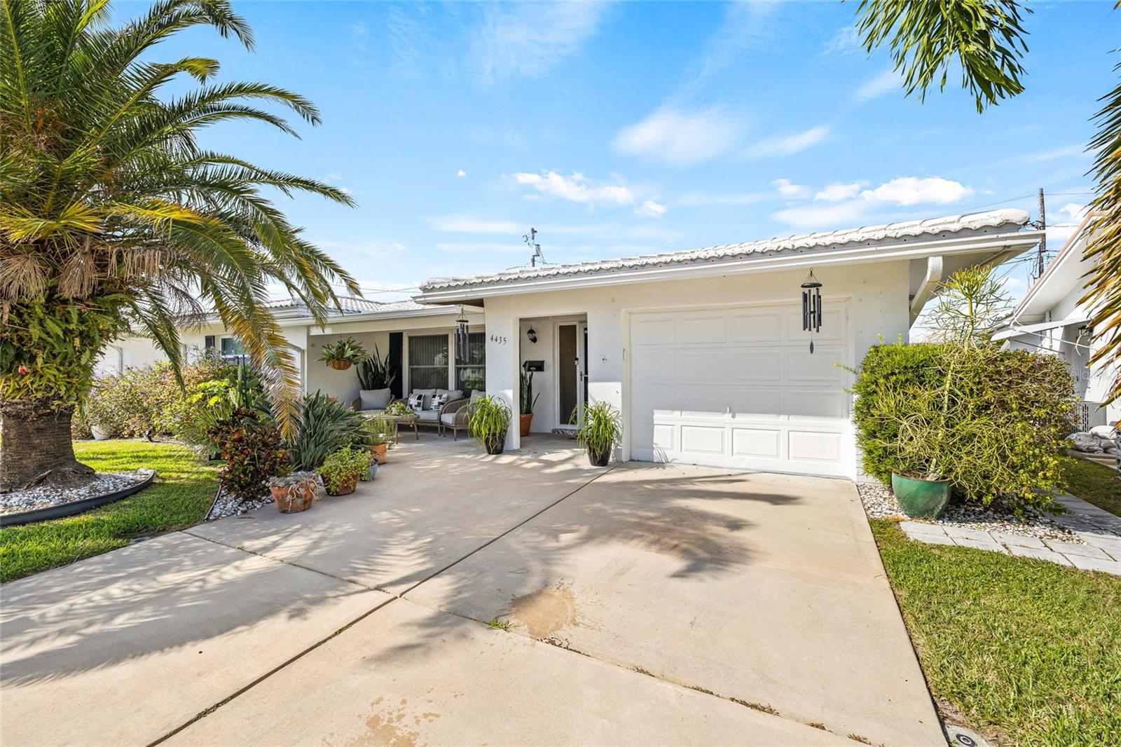 Located in Mainlands of Tamarac by the Gulf, this updated residence offers the comfort of a detached home with the ease of condominium living. The 2-bedroom, 2-bath layout includes 1,598 sq ft of bright, open living space with luxury vinyl flooring throughout and ceramic tile in wet areas. The renovated kitchen features stainless steel appliances, granite countertops, a subway tile backsplash, and ample cabinet storage. In addition to the living room and dining room, the rear enclosed Florida room offers flexible space for a TV room, home office, or alternate dining area. Enjoy both indoor and outdoor living with a covered front porch--an inviting space to greet neighbors--and a rear covered lanai that provides a private retreat for outdoor dining, entertaining, or relaxing. Additional highlights include an attached one-car garage with a dedicated laundry area, central air, and windows on all four sides for abundant natural light. Just down the block you will find the community pool and clubhouse which hosts ongoing social activities. The association fee covers exterior maintenance, roof, lawn care, and community amenities. Convenient to shopping, dining, golf, and Gulf beaches, this move-in ready home offers comfort, convenience, and an active adult lifestyle. Schedule a showing today to experience all this home has to offer.