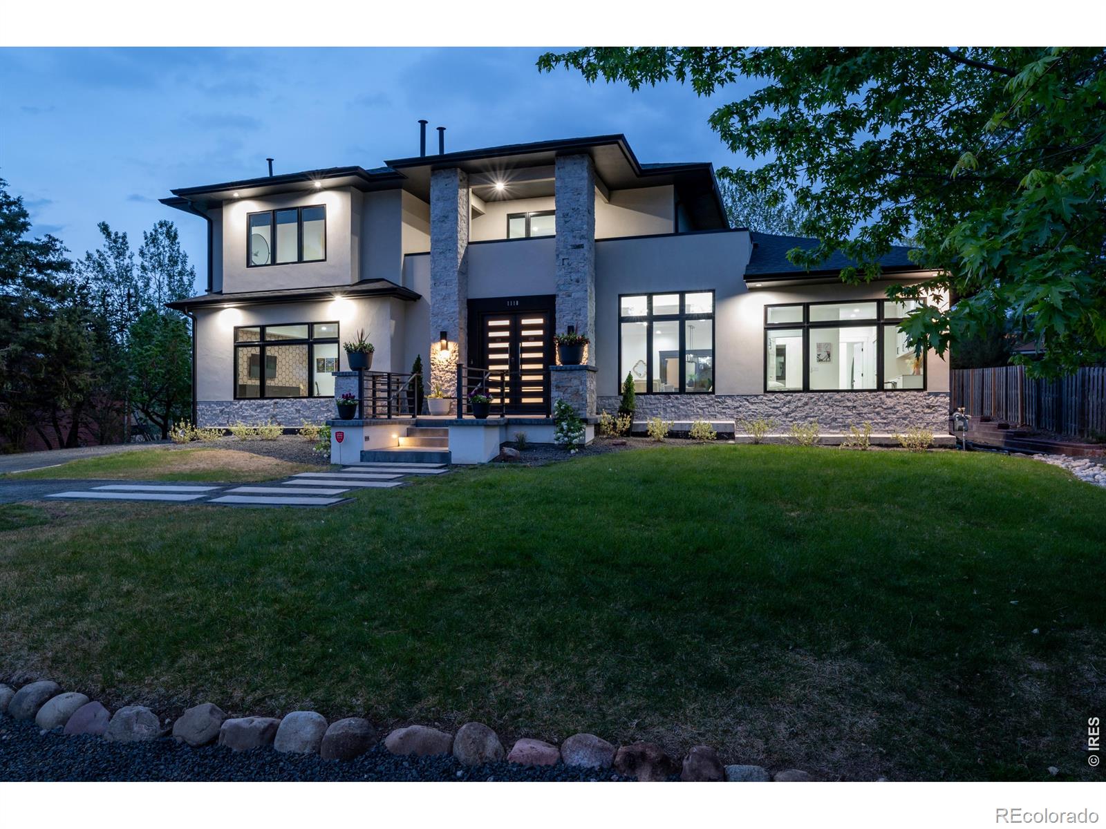 With over $1M invested in renovations, this 1962 Ridglea Hills home was fully reimagined in 2021 with exceptional craftsmanship and thoughtful design throughout. The striking exterior features stone-accented pillars and a contemporary stucco facade, setting the tone from the moment you arrive. Enter the custom iron front doors to be greeted by original lighting, handcrafted stair handrails and even the original front door that was refinished to pay homage to the home's history. The main level offers a bright, open-concept layout designed for both everyday living and entertaining. At the center of the home is a truly custom chef's kitchen, featuring handcrafted cabinetry built by a master carpenter known for creating a Taylor acoustic guitar for Prince. A large island anchors the space and an adjacent walk-in pantry includes a wet bar, GE Sonic ice maker, water filtration system, and extensive custom storage. A versatile main-level office or secondary primary suite includes a built-in Murphy bed and private bath, ideal for guests, office or multi-generational living. Upstairs, the primary suite offers a private retreat with sweeping Front Range and Continental Divide views. The five-piece ensuite includes shower, soaking tub, dual vanities, and a spacious walk-in closet with custom organization. Two additional bedrooms share a well-designed Jack-and-Jill bathroom with separate vanities for privacy. Additional features include 1/2" solid acacia wood flooring, dual high-efficiency HVAC systems with A/C, two Rinnai tankless water heaters, EV charging, a full laundry room, and conditioned storage space. A rare added value: the property includes an approved permit (SPRW-22-0006) for an 864 sqft detached garage with office/ADU. Residents have the ability to enjoy access to Baseline Reservoir Swim Club. Located near Boulder, Louisville, and Lafayette, this home offers a unique opportunity to experience "Lake Life" with close proximity to everything Boulder has to offer.