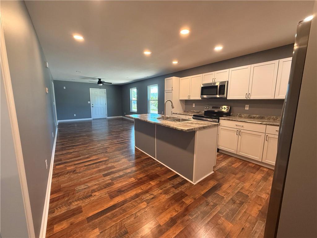 Welcome this this beautifully built new construction home offering 3 bedrooms, 2 full baths, plus an office space across approximately 1,300sq ft. of thoughtfully designed living space on a .20 acre lot. Step inside to a warm, inviting layout featuring a bright open concept design that makes the home feel both cozy and functional. The kitchen is complete with stainless steel appliances (stays with home), plenty of counter space, and beautiful cabinetry. The split bedroom floor plan offers added privacy, white the bonus office space provides flexibility for working from home, hobbies, or addition guest space.  Enjoy your morning coffee on the covered front or back porch.  Located in Osceola, you'll appreciate the small town feel while also being VERY close to the Osage arm of Truman Lake, adding an extra layer of outdoor recreation nearby. Move in ready. 1 year builder warranty. Buyer to confirm dimensions.