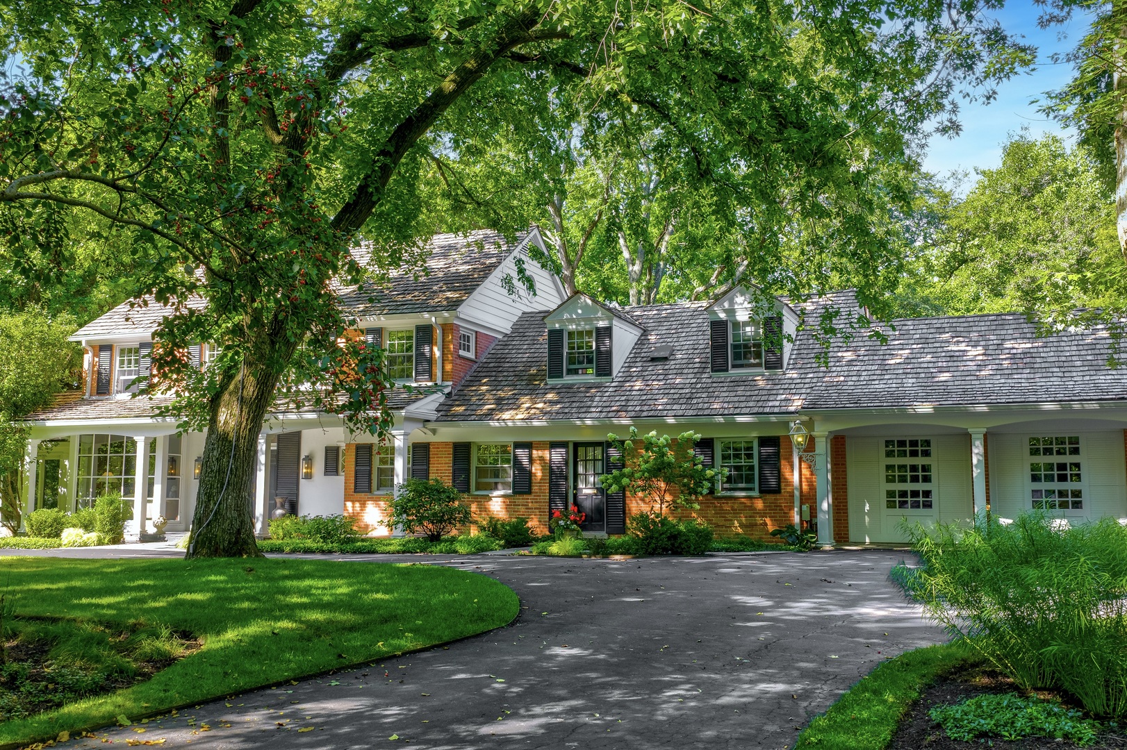 Storybook Cape Cod set on enchanting Apple Tree Road complete with that magical sidewalk to Crow Island School, this red brick colonial accented with classic black shutters and white trim offers timeless comfort in a very special nook! Nestled on a lush half-acre lot with mature trees, a circular drive & attached 2-car garage accented by plantation shutter windows, this home radiates charm with fantastic curb appeal. Inside, the formal entry opens to a cozy wood-paneled office with a bay window overlooking all everyday activity. A sun-filled four-seasons room flows seamlessly into the inviting living room with marble surround where oversized windows frame panoramic views of the huge backyard. The central dining room connects the home's entertaining spaces, leading to the oversized family room with custom built-ins, WBFP and expansive floor to ceiling sliding doors to the entertaining patio & backyard oasis. The front-facing Chef's kitchen keeps you connected to the comings & goings of this special street, featuring granite c-tops, custom cabinetry, s/s appliances & island with breakfast bar seating. Eat-in dining space is ripe to be opened to family room for an open concept dining to great room. A second office/guest bedroom off the mudroom with laundry provides flexibility. Expansive 2nd floor with primary suite overlooking the lush backyard & boasts a walk-in closet with spa bath. Two additional bedrooms share a hall bath, while a fourth bedroom w/2nd staircase down is ideal for guests or an au pair. The lower level offers abundant recreation space, ample storage, and 2nd laundry room. Perfectly positioned steps to Crow Island, New Trier, and Loyola, this home delivers on location & North Shore lifestyle. Warm, welcoming, and brimming with even more ways to bring this home to a new level of luxury, 180 Apple Tree Lane is ready for a touch of 2025 designer vision as you are already in the most premier A plus location as it's all here!