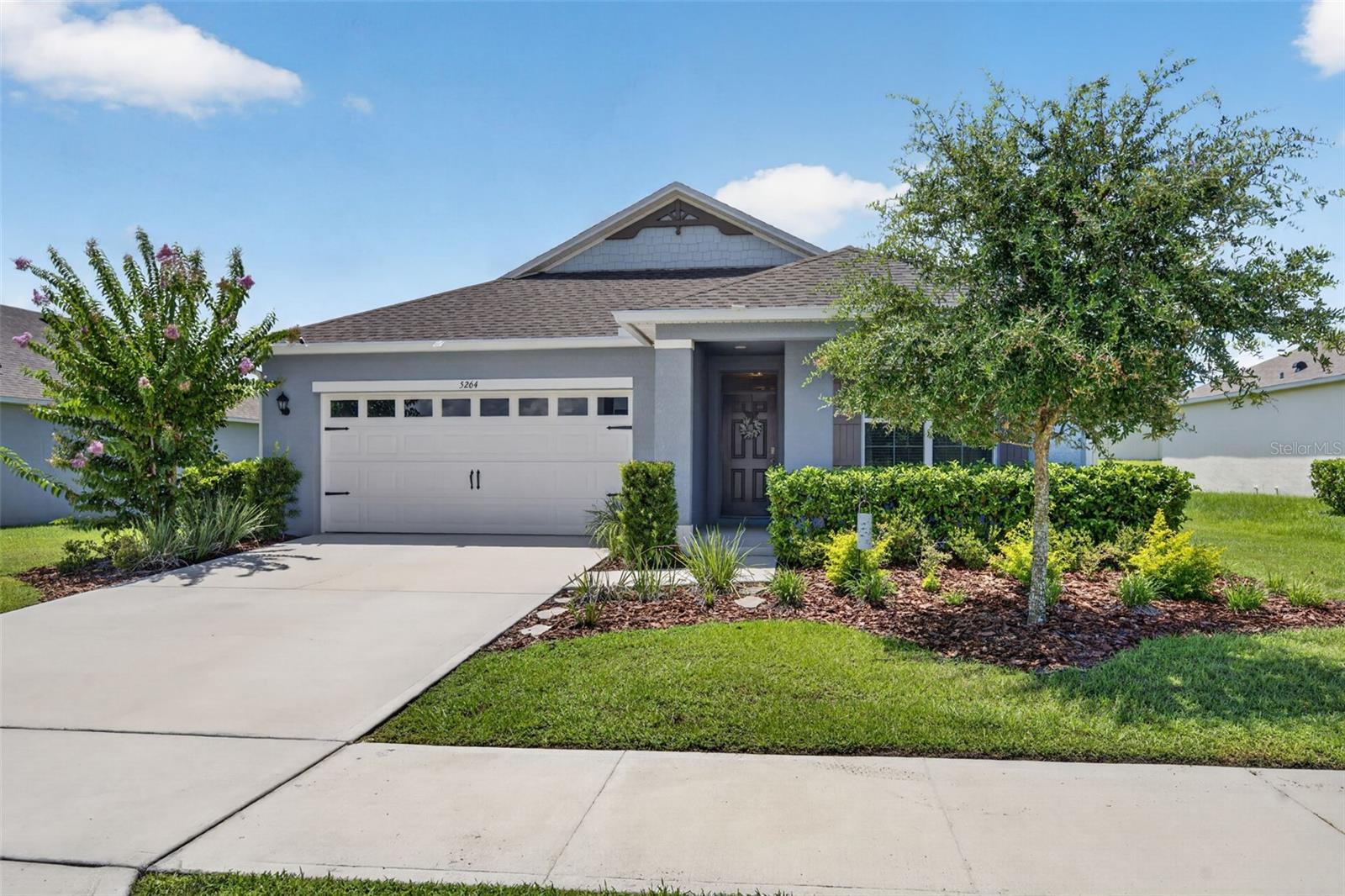 NEW PRICE AND SELLERS OFFERING $2000 TOWARDS BUYER CLOSING COSTS! Enjoy MODEL HOME STYLE without the price tag! This METICULOUSLY maintained 3 bedroom, 2 bath single-story home offers sophistication and charm LOCATED JUST MINUTES FROM HISTORIC DOWNTOWN MOUNT DORA. As you step inside, you’re greeted with a light and bright, open-style layout designed for both relaxed living and effortless entertaining. The flow is seamless with 2 bedrooms just off the hallway (one is currently used as an office w/a decorative fireplace). Then it opens into the Family Room and Kitchen. The kitchen offers stylish cabinetry, granite  countertops and upgraded lighting. The island is large enough to seat 3 and the custom pantry is a chef’s dream. The adjacent generous-sized family room helps create a balance of style, space, and everyday functionality. The dining area has a beautiful model-grade accent wall with designer lighting and is large enough for a to seat 6+. The primary bedroom offers views of the EXPANSIVE FENCED BACKYARD.  The SPA-INSPIRED ensuite bath boasts sophistication with an upgraded shower and double vanity sinks.  There’s a generous sized walk in closet too. The BACKYARD offers an ambiance of peace that allows you to sit back and enjoy a favorite meal or beverage in your screened patio accented by brick pavers. It’s a great place to view a fantastic sunset sky! Additional home features include….smart home security system, house gutters, remote controlled ceiling fans, attic stairs, inside laundry room with built in cabinets, and tilt-in windows (easy for cleaning). The house is 3 DOORS FROM THE COMMUNITY CENTER where all residents enjoy convenient amenities including a sparkling pool, 2 playgrounds, fitness course and walking trails. You’ll love the convenience of being just minutes from the vibrant shops, dining, and waterfront charm of Historic Downtown Mount Dora. The coveted Round Lake Charter school is just around the corner, and less than a 3 minute drive. And for golfers, you’re close to the renowned Country Club of Mount Dora which is open to the public. Orlando and Winter Garden are an easy 35 minute drive making it a prime location to still enjoy the peacefulness of country living and still be connected to the bustle of the city. Make it a priority NOT to miss this one, schedule your viewing today!
