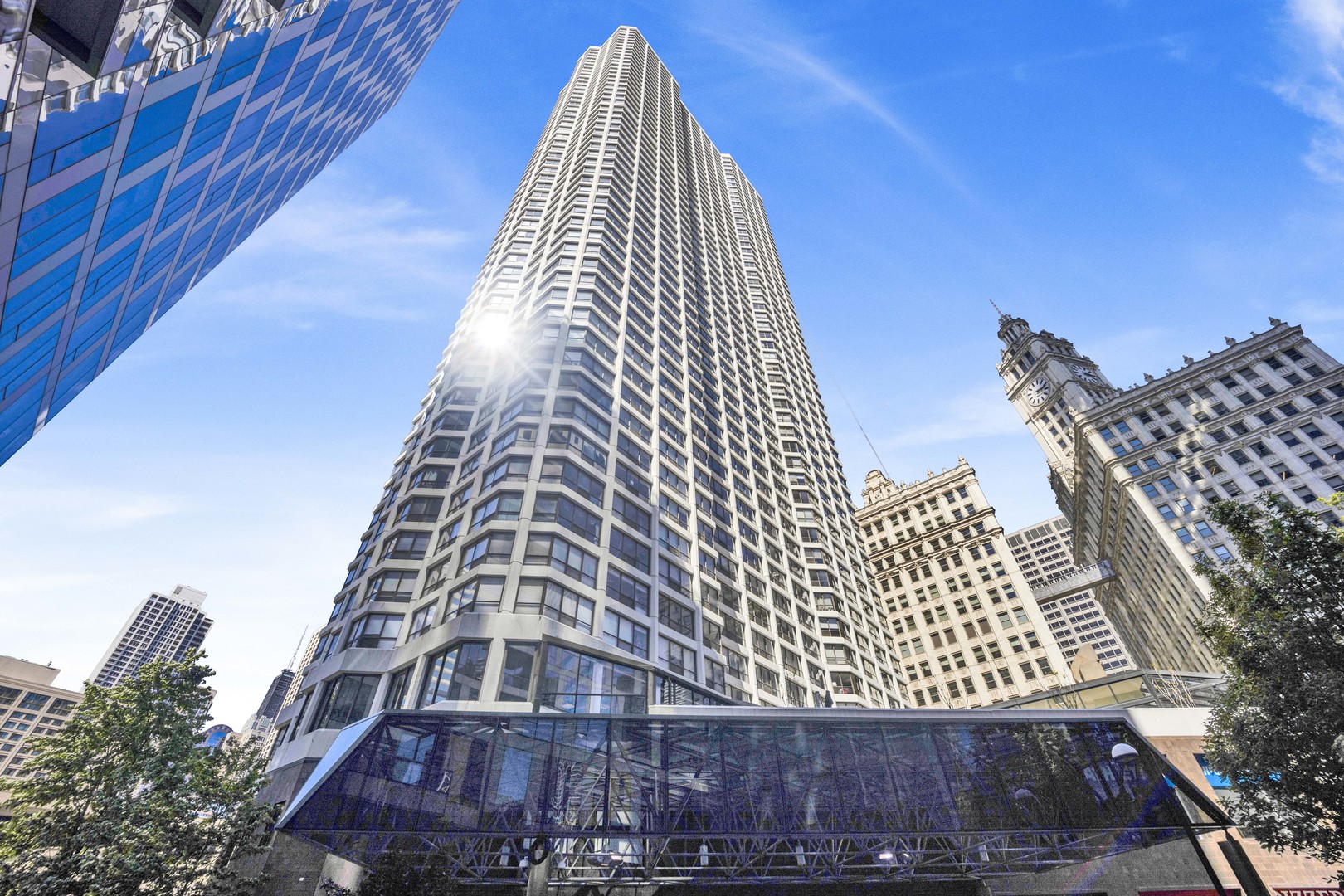 Welcome to a rare opportunity at 405 N Wabash, a nearly 900-square-foot one-bedroom home that blends modern upgrades with expansive living space. This exceptional unit offers unobstructed Chicago skyline views, enhanced by large bay windows that flood the open floor plan with natural light, creating a bright and airy flow from the living room to the dining area.  The newly renovated bathroom is a highlight, designed for both practicality and style. Its modern walk-in shower features sleek fixtures, offering a refreshing and contemporary experience. The oversized vanity provides abundant counter space and generous storage, making this bathroom a functional standout and a rare feature for a unit. In the primary bedroom, a wall of windows fills the space with natural light, complemented by a large walk-in closet with custom shelving. The open kitchen is equally impressive, equipped with stainless steel appliances, granite countertops, and a breakfast bar that's perfect for casual dining or entertaining. Beautiful oak floors, custom lighting, and ample closet space add warmth and convenience throughout the home. The oversized layout, nearly 900 square feet, offers versatility and comfort, setting this residence apart in the heart of Chicago.  Enjoy the ease of a full-amenity building with a health club, pool, sundeck, grocery store, dry cleaners, salon, and restaurant all on-site. Assessments cover doorman, security, heat/AC, cable, water, and common insurance, ensuring a hassle-free lifestyle. Don't miss this unique chance to own a spacious, modernized home in one of Chicago's most desirable locations just off the River Walk. Parking available for lease. Investor-friendly!