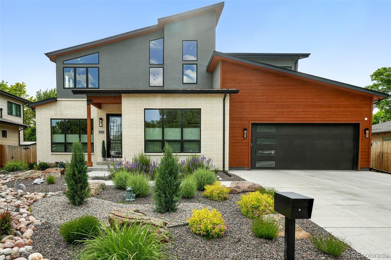 Sleek sophistication meets everyday functionality in this masterpiece by award-winning Champion Construction. Located in a vibrant neighborhood, this contemporary home blends thoughtful design with luxe aesthetics to deliver a truly elevated living experience. A striking double-height entry sets the tone for what lies beyond-sunlit, open-concept spaces designed to impress and perform. At the heart of the home, a luminous great room is anchored by expansive windows and a fireplace, seamlessly connecting to a generous dining area-ideal for both entertaining and intimate evenings. The chef's gathering kitchen is a culinary dream, featuring a 48-inch gas range, state-of-the-art appliances, an abundance of quartz surfaces, and bespoke cabinetry, while an oversized walk-in pantry enhances both style and function. A main-floor office adds versatility for work-from-home days, and a thoughtfully designed mudroom off the kitchen includes built-in bench seating and ample closet space for seamless everyday living. Upstairs, serenity awaits in the primary suite, where a cozy gas fireplace, expansive custom walk-in closet, and spa-inspired bath create a true sanctuary with a freestanding soaking tub, oversized walk-in shower, dual vanities, private water closet, and extra-deep linen closet. Three generously sized secondary bedrooms and two well-appointed full baths offer space and privacy, complemented by a spacious second-floor laundry room that enhances daily ease. Premium materials and finishes echo throughout every room, a testament to superior craftsmanship. An oversized heated, tandem three-car garage with a full-size rear door opens to an expansive backyard with covered patio and large shed, offering unmatched flexibility for storage, hobbies, or entertaining, complete with two EV chargers. Bonus: 1,500 sqft 4-ft tall crawl space for storage. Designed for modern living and built to endure, this exceptional home represents the very best-ready to welcome its new owner.