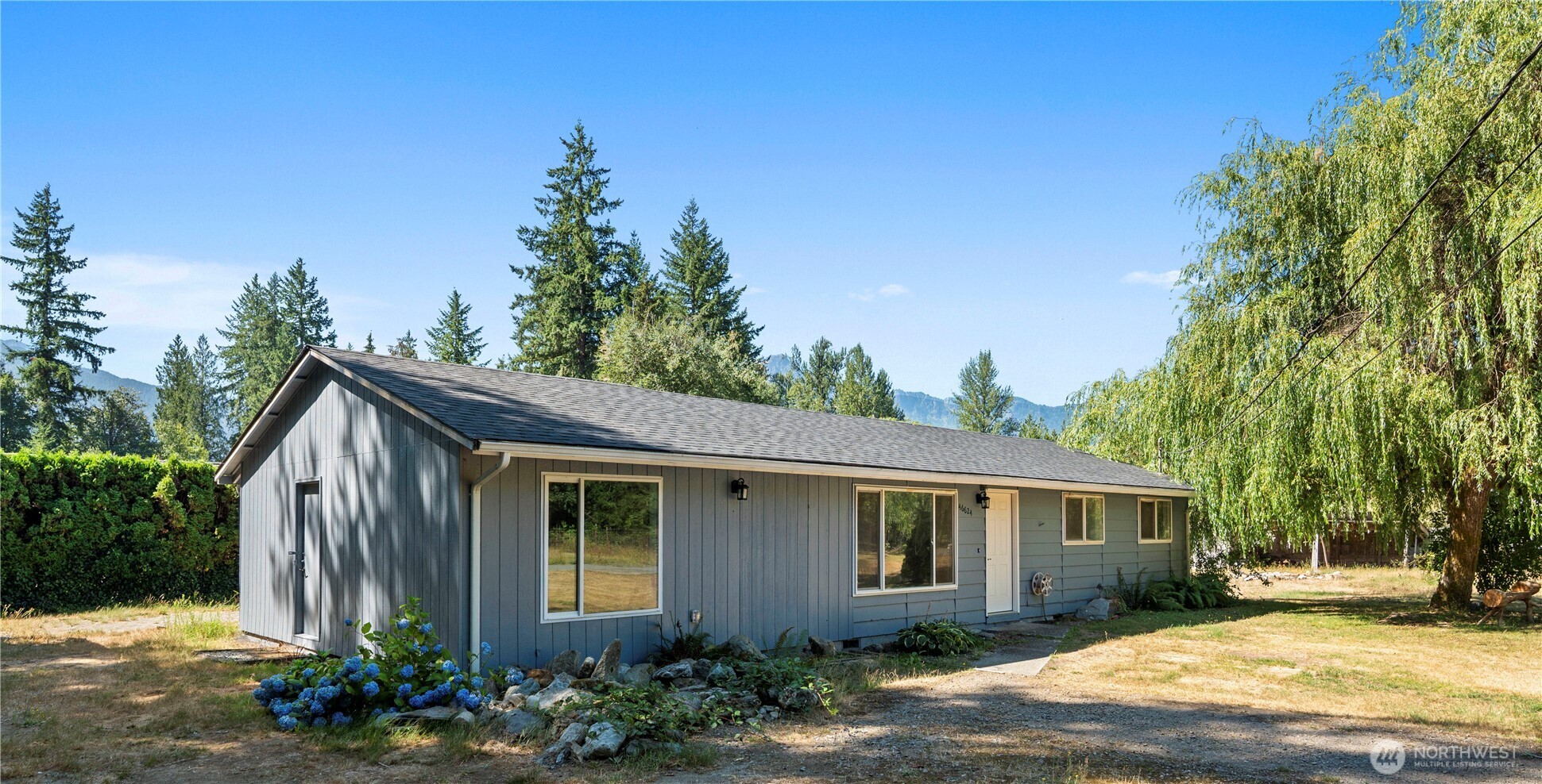 Spacious 4-Bedroom Home on a Half Acre in Scenic Darrington!  This beautiful home offers the perfect blend of modern comfort and small-town charm. Brand-new roof, an updated kitchen featuring stainless steel appliances and new cabinetry with granite counters. The primary bedroom boasts a large walk-in closet and en suite bathroom providing ample storage and a private retreat. With generous outdoor space, there's room to garden, park toys, or simply soak in the breathtaking views of the surrounding mountains.