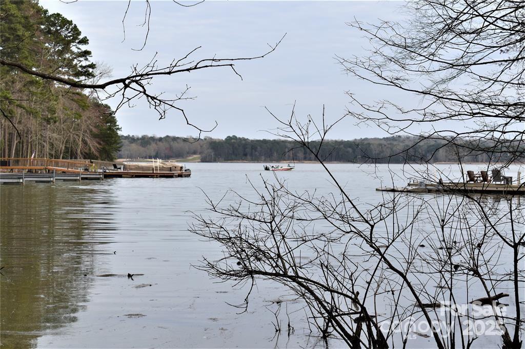 This Badin Lake waterfront lot is located in the prestigious gated community of Heron Bay. Great location near the entrance of the neighborhood. Fairly level .8 acre lot. The club house, paved boat ramp, Marina/Dock B (community boat slips), walking trails, and boat storage are within walking distance. Heron Bay owners have the opportunity to join the adjacent Old North State Country Club. The Old North State Club offers a highly rated golf course, marina, club house, restaurant, pool, tennis courts, and more. Club opportunities require membership. Badin Lake has marinas that provide dining, gas & watercraft rental. The Uwharrie National Forest nearby is a great destination for camping, hiking, horseback riding, and ATV/OHV trails. Within one hour from Charlotte, Greensboro, and Winston-Salem.