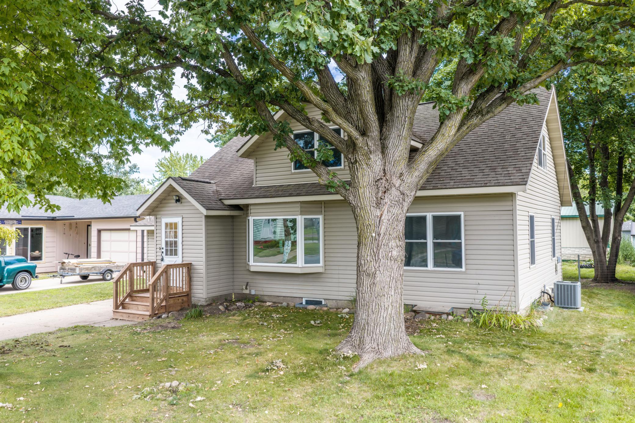 This charming 1926 home in Little Falls' Thayer's Addition has a lot to offer, highlighted by a completely remodeled kitchen and an incredible amount of garage space (over 1200 sq ft!!) that's hard to find in town. The main level features fresh paint throughout and a beautifully updated kitchen with new cabinetry, countertops and gas range, opening to a dining area finished in new luxury vinyl plank flooring with French doors out to the back deck. The spacious living room is brightened by a large bay window and finished with new carpet. There are also 2 main floor bedrooms and a 3/4 bath with tiled shower surround to round out the rest of the main floor. Upstairs you will find 2 additional bedrooms with new carpet and fresh paint, along with a full bath. Down below, the full basement offers a ton of storage potential plus the laundry area and mechanicals, including a newer furnace. Outside, this .21 acre lot is shaded by mature trees and features a fire pit and a back deck ready for your next gathering. The property also includes an attached garage plus two additional garages offering a rare amount of space in town for vehicles, tools, and hobbies of all kinds. With approximately 1,420 finished square feet and updated systems throughout, this home is waiting for its new owner.