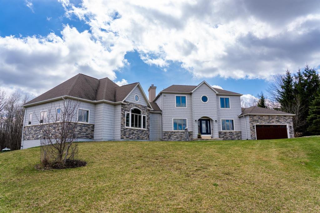 This one-of-a-kind property offers luxury living, recreation, and endless possibilities-all in a private, breathtaking setting on nearly 50 acres. This expansive home offers 6 bedrooms and 4.5 baths, thoughtfully designed for entertaining, and retreat-style comfort. The main-level primary suite is a true sanctuary, featuring a nursery, two large walk-in closets, and a spa-like bath complete with an infrared sauna, dual shower heads with jets, bidet, and custom cabinetry. There is also an office adjacent to the primary bedroom. Laundry room has a dog bath and a laundry pure system that they use in hospitals. A second upper-level primary suite includes its own fireplace and private bath, creating an ideal guest or extended-family space. The lower level features a spacious family room with walk-out access, wet bar, bedroom, full bath, and abundant storage-perfect for entertaining or everyday living. Outdoor amenities truly set this property apart, offering nearly 50 acres of natural beauty with established ATV and snowmobile trails, a scenic bridge in the woods, and a stocked pond with deck, electricity, and water pump. Enjoy evenings around the stone firepit with built-in seating and take advantage of the productive vineyard with grapes and raspberries, all surrounded by serene, private surroundings. A standout feature is the 5,000 sq ft pole barn, complete with concrete floors, multiple oversized doors, RV hookups (30 & 50 amp), enclosed vented workshop with keyless entry, plumbing, loft storage, industrial shelving, and a hoist. The property also includes a private Man Cave (24 x 25) with its own heating and cooling, bar with sink, stage, projector and screen, new windows, insulation, and separate keyless entry. Additional highlights include over 2,000 sq ft of unfinished space ready for customization. Experience exceptional privacy, luxury, and versatility in this remarkable estate!