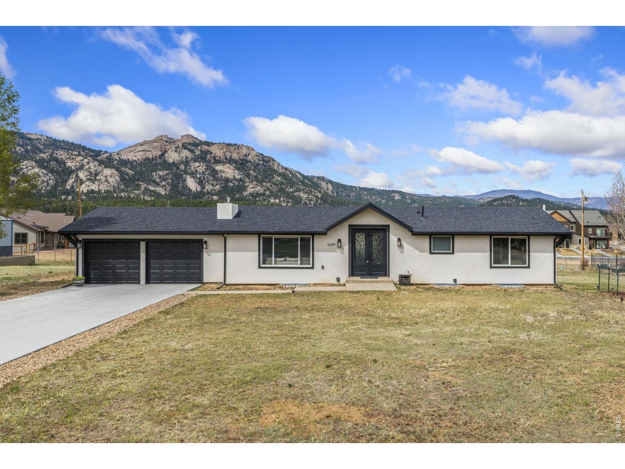 Wake up to Twin Sisters out your front windows and end the day watching the sun drop behind the Continental Divide from your back deck. This is 360-degree mountain living in the heart of Estes Park. 1659 High Pine Dr has been completely remodeled top to bottom, every surface, every detail, and it shows the moment you walk in.The main level lives the way a mountain home should. Kitchen, dining, and living area all open to one another and to the views beyond, with a gas stove and counter space designed for someone who actually cooks. One of three bio-fuel fireplaces anchors the room. The primary suite is on this level, and it's the kind of room that changes your morning: a two-way fireplace shared between the bedroom and the soaking tub, light pouring in, nowhere you need to be just yet.The lower level is its own world. A full kitchen, second laundry, an ensuite bedroom, two more bedrooms, and a private entrance from outside. This versatile dual-living floor plan works for multigenerational living, guest quarters, or extra space to spread out, and the home has been income-producing. However you use it, it's finished, independent, and ready.Step out onto the back deck, and you're facing Lumpy Ridge and the Continental Divide with a flat lot stretching out below you. The street dead-ends past your driveway. The only sound is what the mountain gives you. Lake Estes Marina is less than a mile down the road, downtown is under two, and the Fall River entrance to Rocky Mountain National Park is about six and a half miles up the road. A/C, nearly three thousand square feet, five bedrooms, four baths, two-car garage with extra storage.The remodel is done. The views are forever. The life you've been planning starts here.