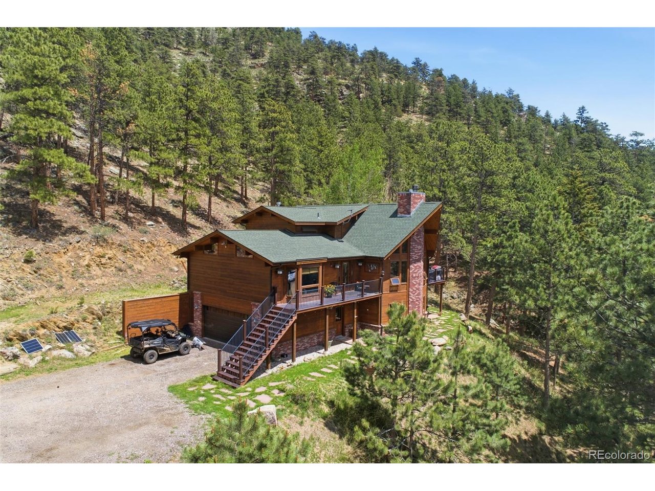 Secluded home on 35 wooded acres with breathtaking views, abundant wildlife,  and excellent hunting opportunities. Ideally located 15 minutes from Carter Lake, Pinewood Reservoir, Flat Iron Reservoir, and soon to be Chimney Hollow Reservoir with easy access to fishing, boating, hiking, camping, and outdoor recreation.Inside, you'll find hickory wood floors, beautiful woodwork, a spiral staircase, three fireplaces, and a spacious kitchen with a gas range and walk-in pantry. The upper-level primary suite features a fireplace, and walk-in closet. The walk-out basement includes a rec room, steam shower, and gas stove.Enjoy the peaceful mountain setting from the front and side Trex decks or the covered lower-level patio. Home is complete with a furnace, central air, and 220 wiring for a hot tub, this is Colorado mountain living at its finest.