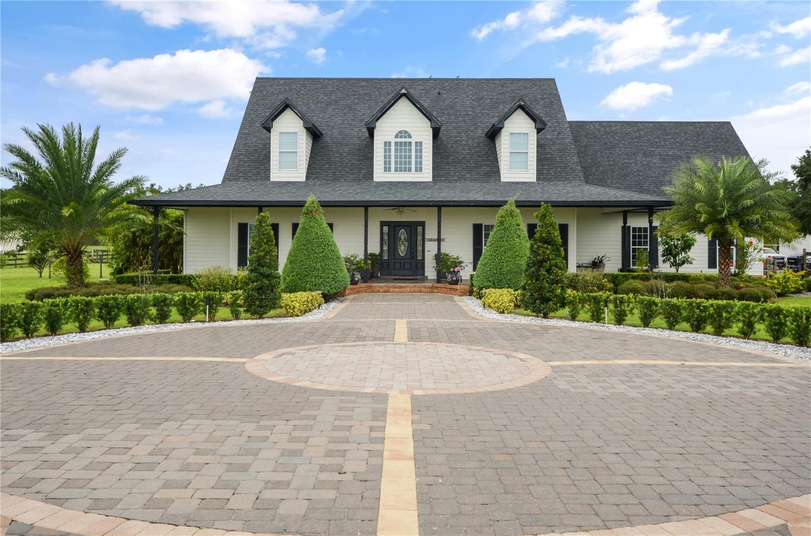 ** Zoning allows for developers and investors to build small subdivision; up to 2 house allowed on an acre. **Sprawling 5-acre cleared and high and dry, this magnificent 4-bedroom, 3-bathroom home offers luxurious living with a blend of modern elegance and country charm. The two-story residence features marble floors and countertops, enhancing the open-concept plan that flows effortlessly from the kitchen with breakfast bar to the spacious family room and dining areas. Upstairs, a loft style media/game room provide perfect spaces for relaxation and entertainment. The Zen- like primary suite boasts an inviting tub and bath, while the additional bedrooms adds ample space for family or guests.Step outside to your private oasis with a sparkling pool, spa, and huge screened lanai, unforgettable fire pit —ideal for year-round outdoor living and star gazing. A charming front porch invites you to enjoy the peaceful surroundings.The property also includes a separate in-law suite, perfect for extended family or guests, as well as a large barn/workshop with bathroom for work and play. The beautiful cobblestone driveway adds a touch of sophistication as you approach this hidden gem.This is country living with luxury, offering space, privacy, plus wide range of entertainment at NorthWest Sports Complex/Amphitheatre, Ask about rare development opportunity for small subdivision. The perfect environment for your serene retreat. Hurry; Don't miss out ! Call today for appointment ... Bring the horses !!