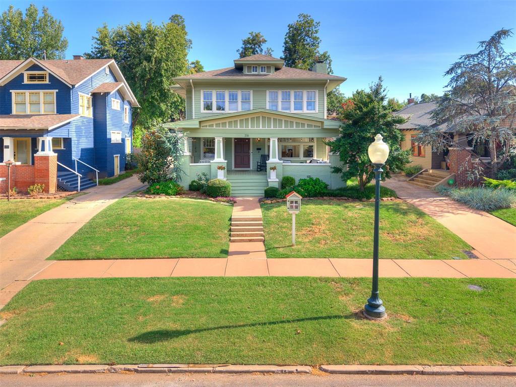 Set on a picturesque, tree-lined street in Heritage Hills, this home is a masterfully updated 1919 craftsman bungalow where historic character meets elevated, modern luxury. A deep covered front porch offers an inviting first impression that carries through every room.Inside, gleaming hardwood floors and crown molding set the stage for a living room centered on a dramatic black-glazed brick fireplace, framed by custom built-ins. A flexible space for a lounge and the large adjoining dining room create additional entertaining space. The chef's kitchen delivers true high-end finish: crisp shaker cabinetry, quartz counters, a farmhouse apron sink, premium stainless appliances, and a striking exposed brick accent wall paired with reclaimed brick flooring that extends into a stylish mudroom and laundry nook with a custom window-seat and a half bathroom.The primary suite is a private retreat, featuring a spa-caliber en-suite bath with a freestanding soaking tub, dual vanities, hexagon marble flooring, and a marble mosaic walk-in shower with rainfall showerhead. Two additional bedrooms and a thoughtfully appointed full bath complete the interior, each finished with the same level of designer polish found throughout.Outdoors, a fully fenced, expansive backyard offers rare space for a home in this coveted historic district — ideal for entertaining or outdoor living.