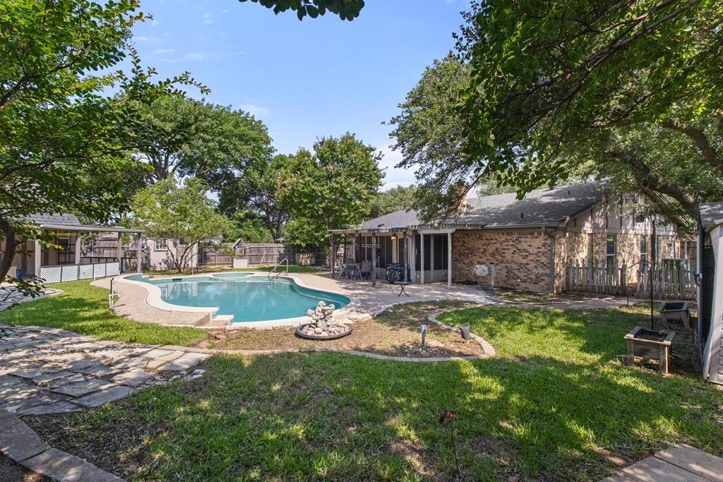 Location, Location, Location! This property is conveniently situated just a short drive from DFW Airport and Fort Worth, offering easy access to everything in the DFW area. This beautifully updated home is nestled in a well-established neighborhood. Inside, you'll find new flooring, fresh paint, and modern fixtures. The spacious living room, featuring vaulted ceilings with skylights and a fireplace, opens to the kitchen. The kitchen itself boasts updated appliances and granite countertops, making it a delightful space for cooking and dining. The sunny breakfast area has great windows and built-ins. The expansive master suite includes a private bathroom with double closets and a large walk-in shower. The secondary bedrooms, also generously sized and equipped with walk-in closets, share an additional updated bathroom with a jetted tub. As you step into the backyard oasis, you can envision yourself relaxing by the pool and spa in the screened-in patio. The pool is stunning, with an attached spa perfect for unwinding. Additional storage sheds offer plenty of space, and the large shed can be transformed into a workshop or a she shed. The property also includes a two-car attached garage and extra parking in front, with a short walk to the nearby park. This home is move-in ready and waiting for you to create lasting memories!