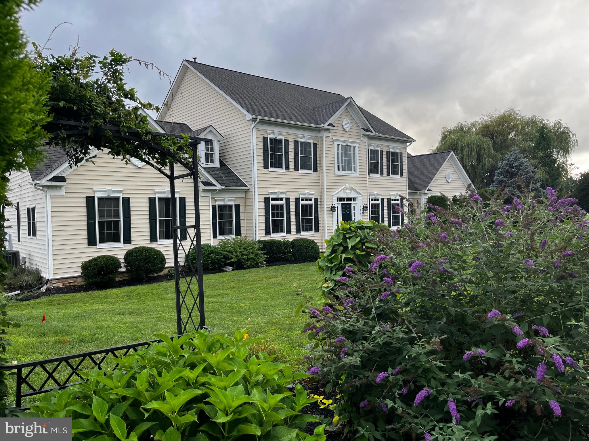 Exceptional Colonial Estate in the Heart of Western Loudoun in Purcellville, VA 20132 with a Primary Bedroom on the Main Level.A rare opportunity to own an expansive 6,600 square foot Colonial nestled on 3 beautifully landscaped acres in sought-after Western Loudoun. Mature trees, lush landscaping and impeccably manicured ground create a private, park-like setting. Stunning gardens in both the front and rear of the home evoke the feeling of a peaceful countryside sanctuary yet it is right off the major highway, Route 7. This exceptional property offers an inviable combination of privacy and convenience with very easy access to Washington, DC, the Dulles Greenway, Dulles International Airport, Leesburg business center and major commuter routes.Designed for both gracious living and entertaining, the property features a spacious patio overlooking the beautifully appointed grounds. It is an idyllic setting for your morning coffee, al fresco dining or gatherings with family and friends.Experience the quintessential Western Loudoun lifestyle surrounded by rolling countryside, renowned wineries and breweries, working farms and picturesque horse country.A distinctive estate offering space, serenity and an unparalleled connection to the beauty of Western Loudoun.