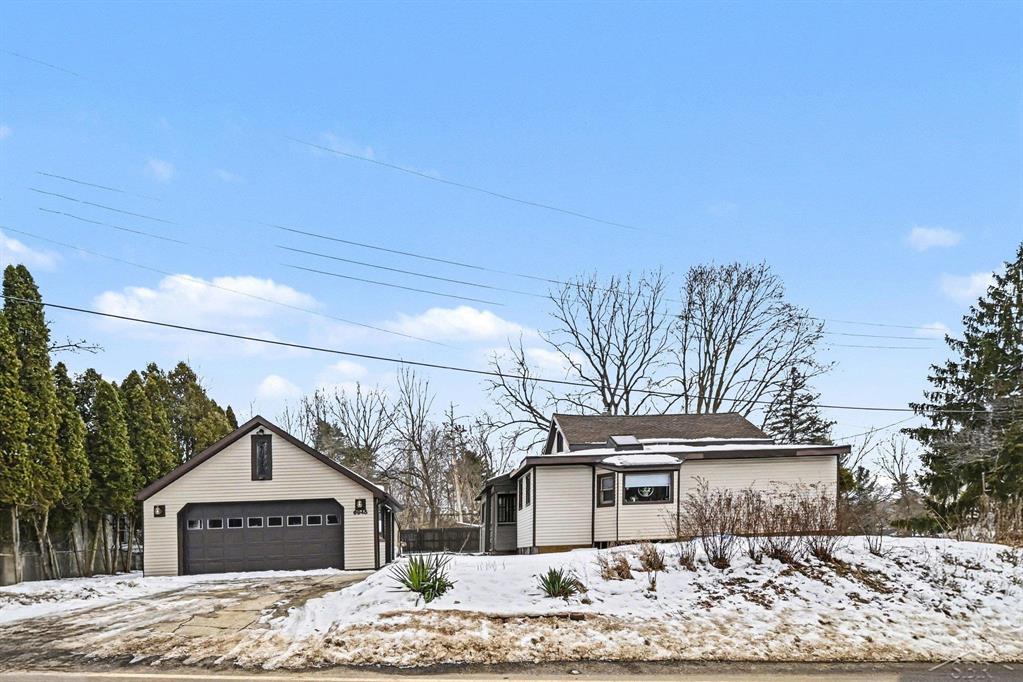 Welcome to 6945 Delta River Drive in Lansing! This 3-bedroom, 1-bath home offers over 2,100 sq ft of living space with warm wood accents, a spacious living area, and a bright dining room with skylight. The kitchen provides ample cabinet space and overlooks the backyard. Upstairs features additional finished space perfect for a bedroom, office, or bonus room.  Outside you'll find a detached 2-car garage, storage sheds, and a generous yard with mature trees.