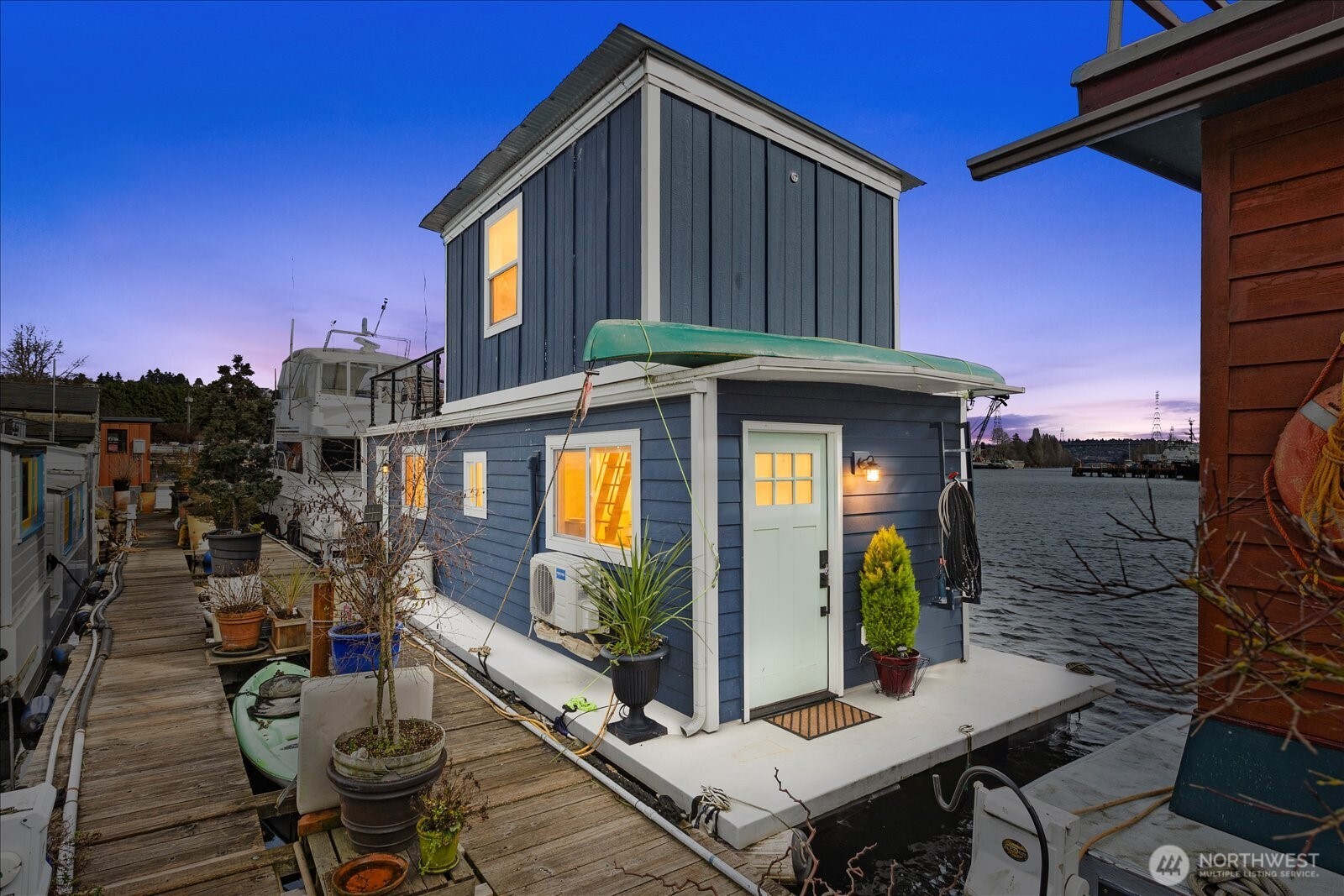 Step aboard your own slice of Seattle waterfront paradise with this beautifully remodeled houseboat, perfectly positioned along the scenic canal leading to Lake Union. Offering sweeping water and territorial views, this floating retreat blends modern upgrades with the tranquility of life on the water.  Thoughtfully redesigned throughout, the home features walls of double-paned windows that flood the interior with natural light, new laminate flooring, recessed lighting, and mini-split heat/AC for year-round comfort. Updated electrical and plumbing provide peace of mind, making this home truly move-in ready.  The stylish kitchen is appointed with quartz countertops and generous storage, seamlessly flowing into the inviting main level. Here you will find a cozy living area, charming dining nook, ¾ bath, convenient laundry space, and a versatile home office nook - ideal for today’s flexible lifestyle.  Upstairs, the private bedroom retreat includes a custom closet and direct access to an expansive deck, the perfect place to enjoy morning coffee, sunset dinners, and panoramic canal views.  Moorage details: rented slip at $762.30/month, plus $250/month liveaboard fee and $20/month garbage.  Located with easy access to city amenities and the popular Lake Washington Ship Canal Bike Trail, this home invites you to bring your bikes, kayaks, and paddleboards to fully embrace the waterfront lifestyle.  Experience the magic of canal living — where every day feels like a getaway.