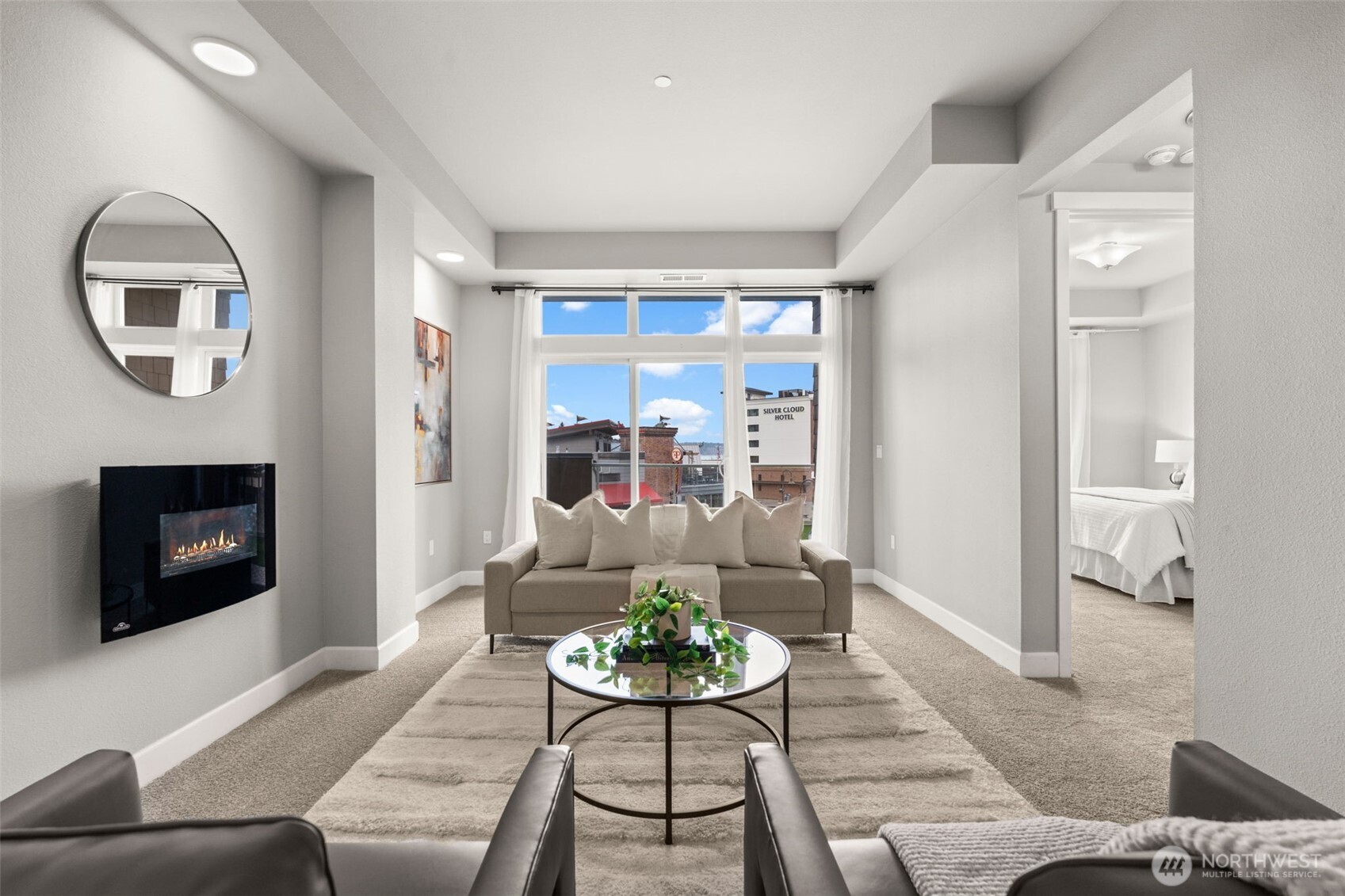 Welcome to luxury living in the heart of Point Ruston with views of the water and the Cascade Mountains! This beautiful 2-bedroom, 2-bath Century Condo offers the perfect blend of location, lifestyle, and comfort in one of Tacoma’s most vibrant waterfront communities. Inside, you’ll find a chef’s kitchen featuring a natural gas range, stainless steel appliances, and ample counter space, ideal for cooking and entertaining. The open great room creates a bright and inviting space to relax or host guests. The spacious primary suite includes a walk-in closet and a well-appointed bathroom with a walk-in shower. One of the standout features of this home is the expansive patio, accessible from both the great room and the primary bedroom, offering stunning water and street views with plenty of space for outdoor dining, entertaining, or simply enjoying the energy of the waterfront. Additional highlights include a private storage unit, two parking spaces conveniently located next to the elevator for easy access, and brand new carpet. Just steps from waterfront dining, shopping, trails, and the Point Ruston waterfront, this condo offers an incredible opportunity to enjoy a walkable lifestyle in one of Tacoma’s premier destinations. A beautiful condo in an unbeatable location—come see it for yourself!