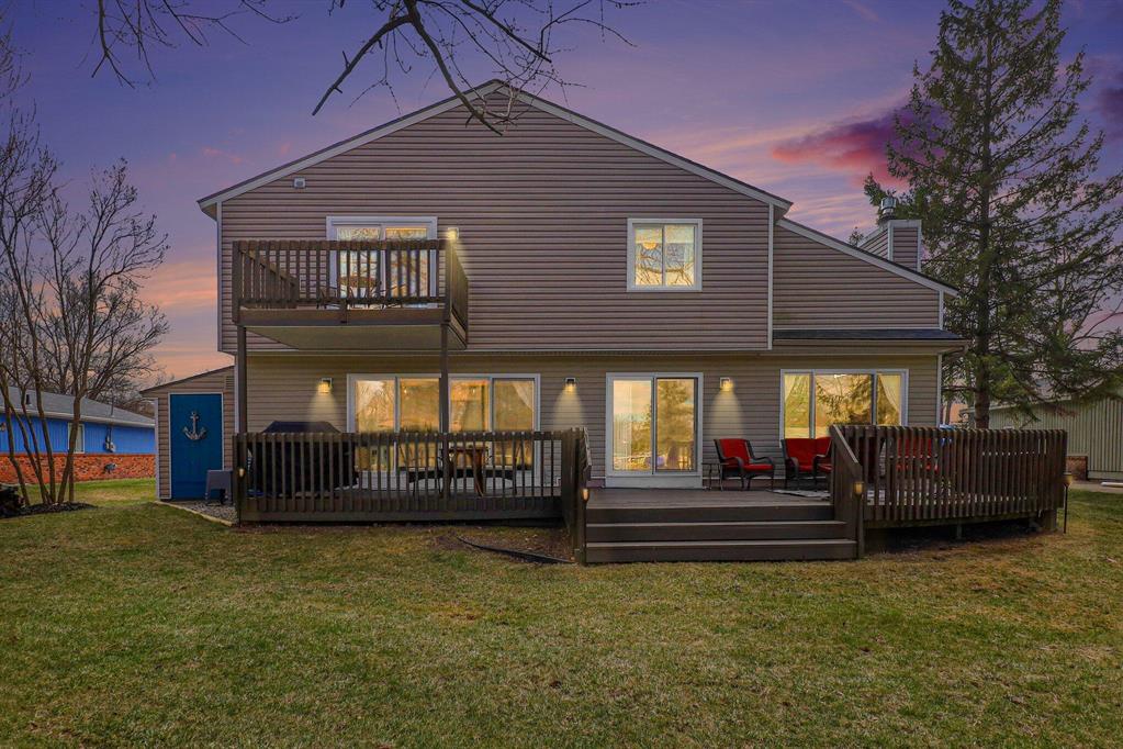 Welcome to this fully remodeled 3 bedroom, 2.5 bath home on the Portage Chain of Lakes in Pinckney. This stunning, turnkey property offers all the amenities for modern comfort paired with features that lend itself to many fun-filled days of entertaining and enjoying lake life. Situated on the canal of all-sports Base Line Lake, this exceptional home boasts a water view from every window! The open concept main level is thoughtfully designed with stunning hardwood floors and a rear wall of glass featuring a large picture window and multiple doorwalls, creating a bright, airy atmosphere and seamless access to the expansive deck and 63 feet of canal frontage complete with a steel seawall and private boat dock that can accommodate multiple boats. The chef's kitchen is the true centerpiece, featuring an expansive granite island with plenty of seating, stainless steel appliances, reverse osmosis water filtration, abundant cabinetry and beautiful pendant lighting.The living room showcases a vaulted ceiling with exposed beams and a Heat and Glo gas fireplace, creating a warm and inviting gathering space. The main level also offers a centrally located dining room, a rec room with wet bar, a convenient half bath, and a large storage room off the kitchen. The beautifully crafted custom railing accents the staircase leading to the 2nd floor where you'll find three spacious bedrooms including the primary en-suite boasting a door wall leading to a private balcony overlooking the water, a bathroom with double vanity and a generous walk-in closet. The upper level also includes the home's 2nd full bathroom with double vanity and convenient laundry room.The 2.5 car attached garage includes it's own furnace and houses the home's premium water softener and filtration systems. Enjoy added peace of mind with your whole-house generator, new roof (2023), newer Pella windows (1st floor 2019, 2nd floor 2024) and newer furnace (2020). All furniture is negotiable except the bicycle bar.