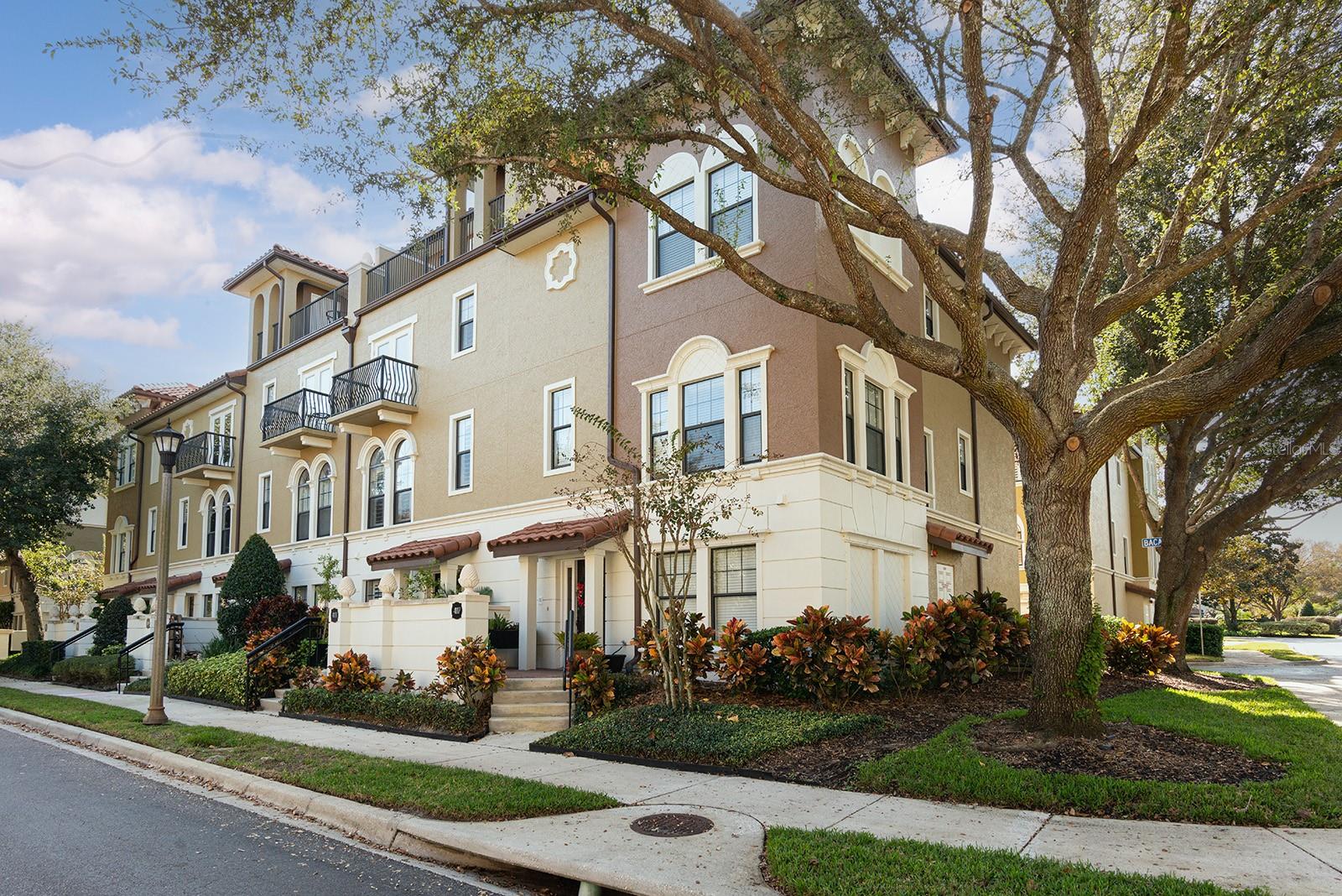 Indulge in the ultimate luxury lifestyle nestled within the 24-hour guard-gated community of Fountain Parke at Lake Mary. This exceptional 3-bedroom, 4.5-bath, 4-story Mediterranean-inspired townhome with a private ELEVATOR offers elegance and convenience at every turn. The exterior boasts a stucco façade, terracotta tile roof, and an inviting front patio with lush landscaping.  While inside, you will find freshly painted neutral walls, newer warm engineered hardwood floors, and new plantation shutters throughout.  Once inside, the bright, inviting foyer leads to a first floor guest suite with a full bath and easy walk-in shower.  The spacious two-car garage will meet your extra storage needs with custom storage that conveys with the sale.  The Sellers had an EV charger installed for the new owner's convenience!  The second floor boasts sun-filled living and dining spaces framed by arch-topped windows.  The gourmet kitchen dazzles with newer stainless steel Samsung appliances, granite countertops, and 42” upper cabinets.  The bedrooms feature an enviable amount of closet-storage space and serene views with a private balcony and an exterior storage room. The primary suite offers plush comfort with his and her custom-designed closet space and a primary bathroom complete with dual vanities and a shower with a soaking tub. The fourth floor offers more indoor space for movie nights, a pool table or a fourth bedroom.  Another private balcony and a rooftop terrace elevate outdoor living on the fourth floor with a full kitchen, wet bar, and grill—perfect for hosting under the stars.  Additional peace of mind comes with a new HVAC system, ensuring year-round comfort.  Enjoy resort-style amenities including a community pool and hot tub, tennis and pickleball courts, putting green, dog park, clubhouse, and fitness center.  Ideally located near I-4 and major roads, golf courses, shopping, dining, and major attractions, with Orlando, Disney, and Florida’s beaches just minutes away, this home delivers an unparalleled blend of sophistication and convenience.  Schedule your private tour today and make this extraordinary residence yours.Video and/or audio surveillance with recording capability may be in use on these premises.  Conversations should not be considered private.