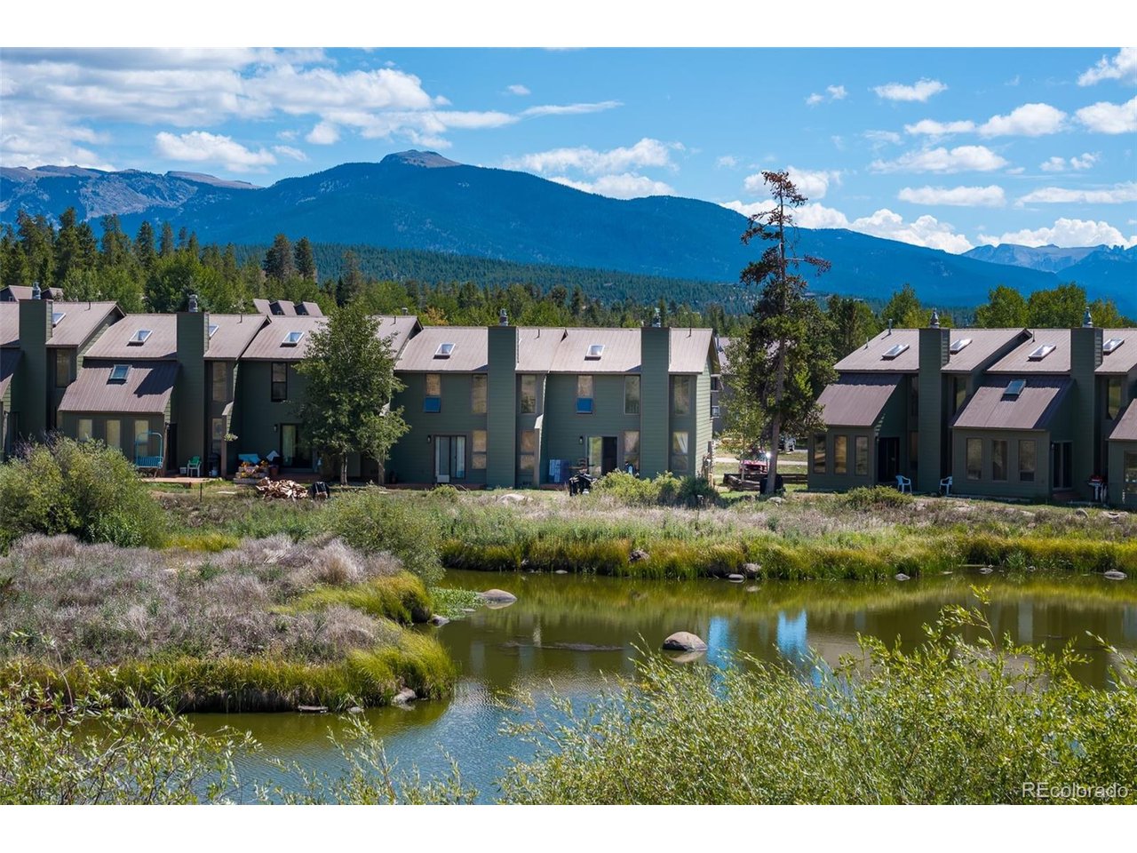 Tucked into the peaceful back of Soda Springs, this 3-bedroom, 2-bath condo offers a serene mountain setting and an incredible opportunity to bring your vision to life. Surrounded by nature and just a stone's throw from Lake Granby, it's a place with the potential to become the mountain retreat you've been imagining. Inside, this end unit features high ceilings and abundant natural light, giving the living room an open, airy feel, while the gas fireplace creates a cozy focal point for gathering after a day in the mountains. The original loft has been enclosed to create the third bedroom, adding flexibility to fit whatever your needs may be. Ready for your personal touches, this is a chance to reimagine the interior and create a space that reflects your own style.The setting is what truly sets this condo apart. Overlooking a peaceful pond at the back of the community, you'll have a front-row seat to nature and wildlife, while the front deck offers views of Lake Granby. The building has also seen significant exterior improvements, including new siding and decks.When you're not out enjoying the lake and surrounding mountains, Soda Springs offers a pool, hot tub, sauna, tennis and racquetball courts, weight room, playground, and clubhouse with a pool table and gathering space.Bring your ideas, embrace the potential, and create the mountain retreat you've been imagining.