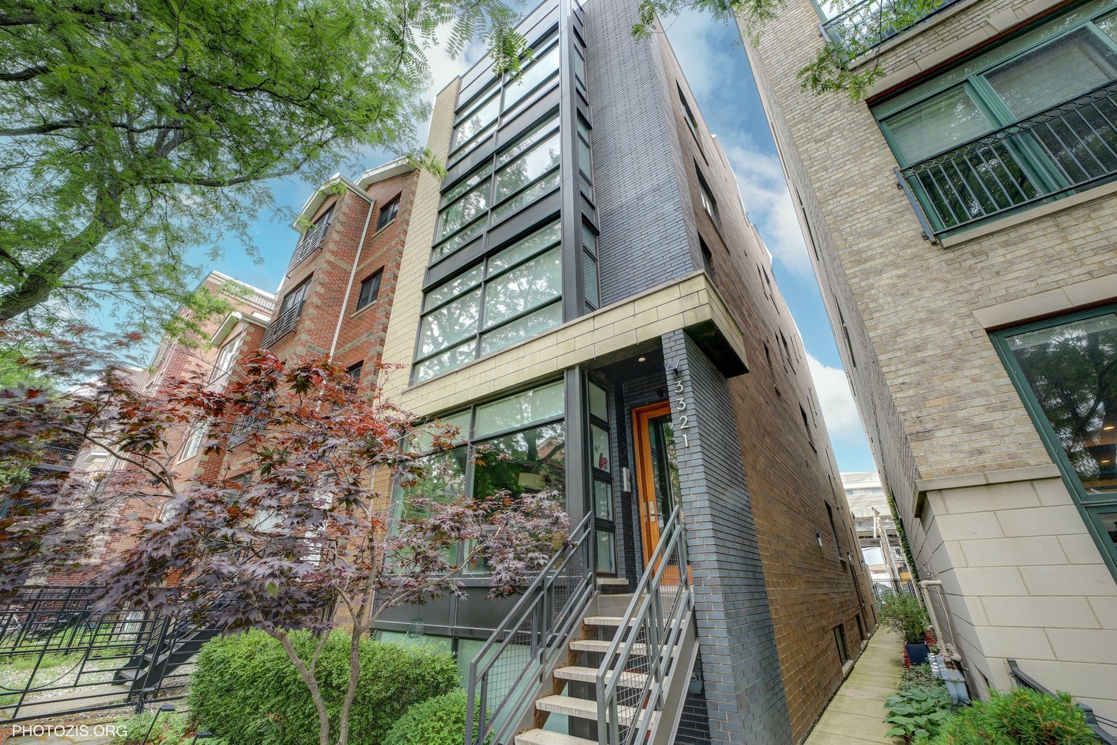 Experience luxury living in this contemporary penthouse with 9.5ft ceilings featuring 2 bedroom, 2 bathrooms and a PRIVATE rooftop deck-plus additional deck off the primary suite and 1-car garage, all in a premier Lakeview location within 0.2 mi to Belmont Red/Brown/Purple line station and 0.4 mi to Wrigley Field. Step into an open-concept home with just painted interior, new can lights throughout, floor-to-ceiling windows in living room, espresso-stained hardwood floors, and a wood-burning fireplace with gas starter. The chef's kitchen boasts eating island, custom walnut cabinets, a glass mosaic backsplash, granite countertops and high-end Viking/ Bosch/JennAir appliances.  The spacious primary suite offers a walk-in closet and a spa-inspired bath with a whirpool tub, rain shower, body sprays and heated floor. Updated mechanicals add extra value with new furnace (11/2022), A/C (2022), water heater (5/2024) & washer/dryer (4/2024).  Enjoy modern elegance throughout this all-brick, extra wide building, thoughfully designed with triple pane sound-deadening glass at the rear, and wired for sound, iPod and Internet. A rare find combining functionality and style in one of Chicago's most sought-after neighborhoods!